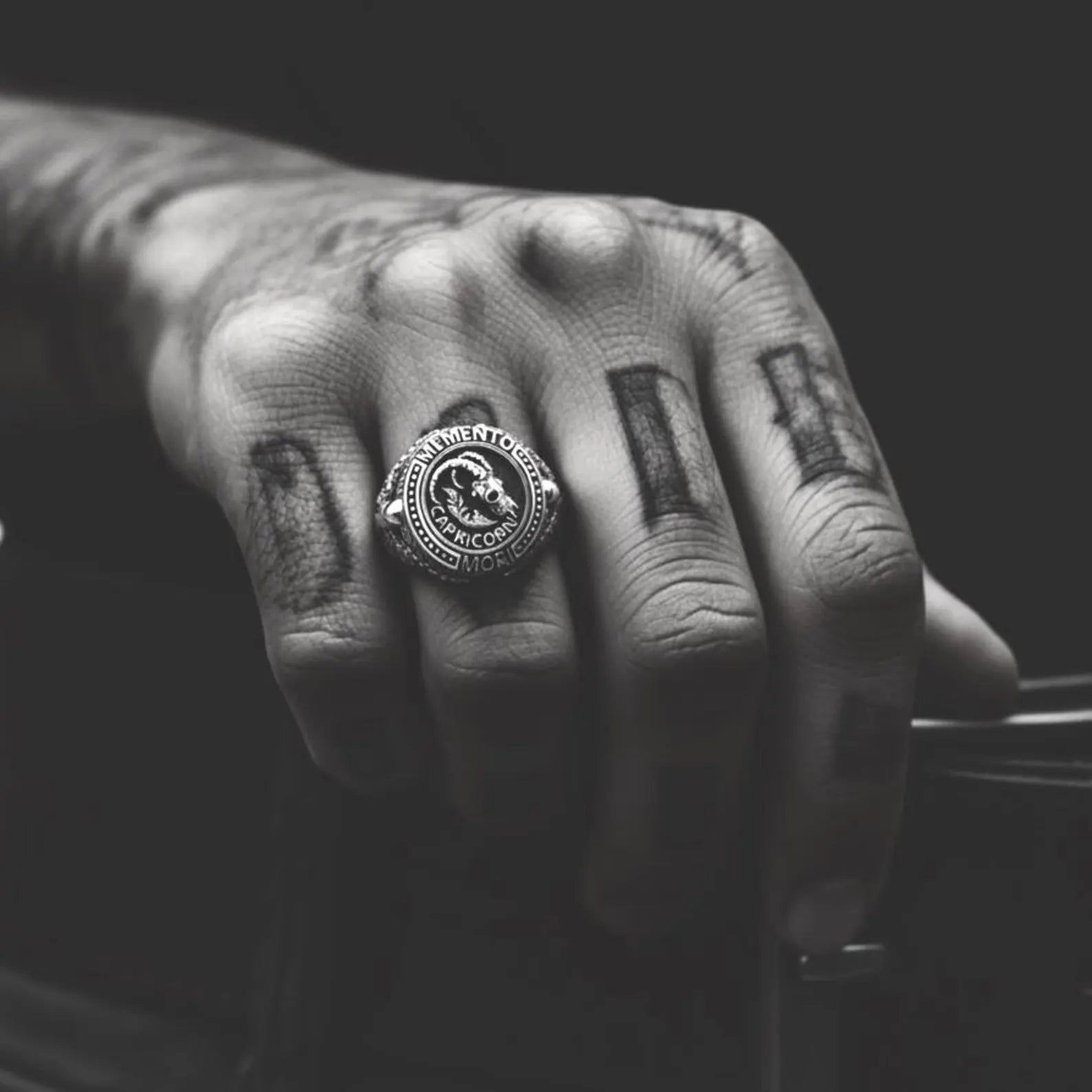 Detailed view of a Memento Mori Capricorn ring highlighting the goat skull centerpiece, oxidized silver finish, and deep handcrafted textures.