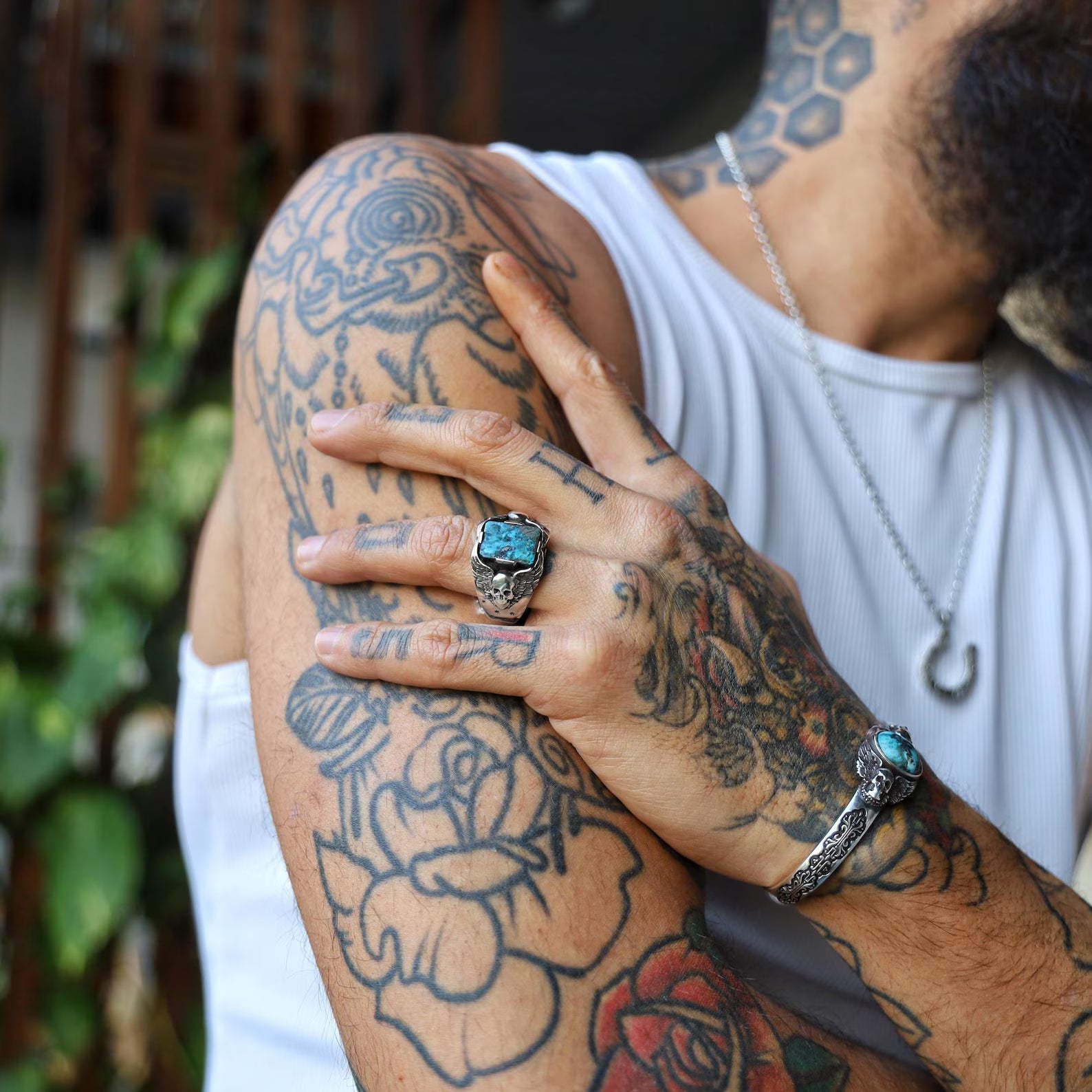 This handmade men's turquoise skull ring is crafted from solid sterling silver and features a striking natural turquoise stone set between two intricately carved skulls. Designed with gothic and biker style in mind, it's the perfect jewelry piece for Harley Davidson lovers and bold personalities who love to stand out. Ideal as a unique gift for him, this rugged ring embodies rebellion, strength, and raw elegance.