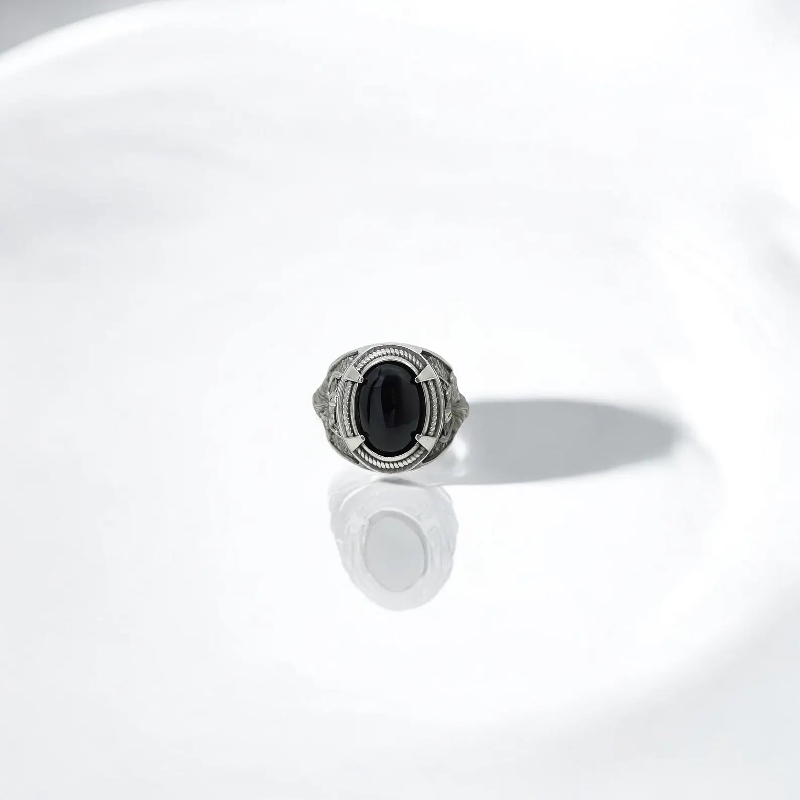 Detailed sterling silver men's ring featuring a smooth black onyx cabochon and powerful wolf imagery. This piece is a fusion of Norse legend and handcrafted mastery, perfect for those drawn to totemic energy, gothic fashion, or Viking heritage. A unique and expressive design that brings together mythology, masculinity, and modern style.