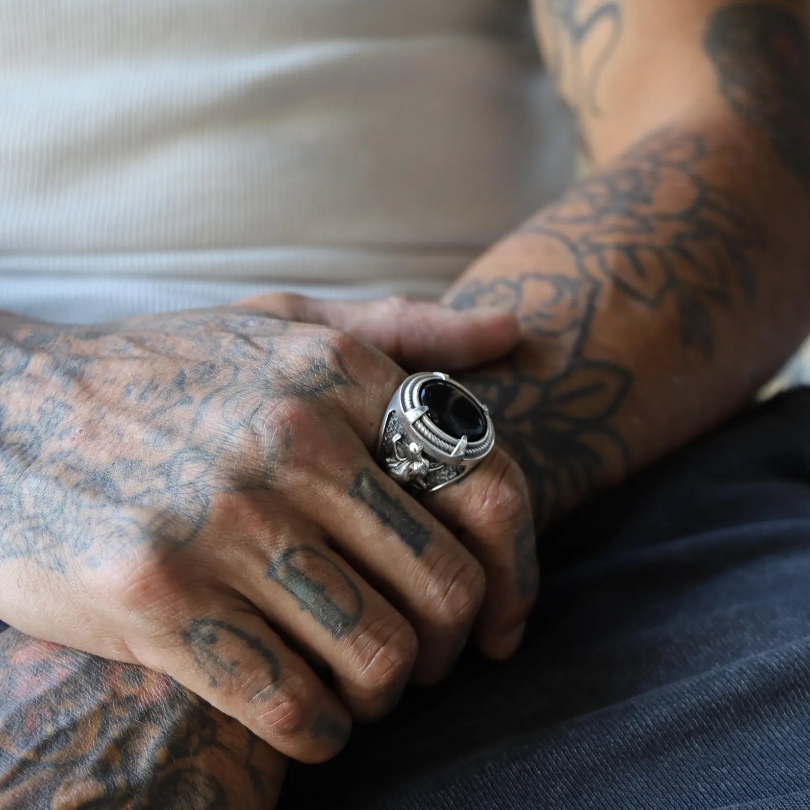 Striking handcrafted silver ring showcasing a gleaming black onyx at its core and lifelike wolf motifs sculpted into the sides. This gothic-style accessory is a powerful representation of inner strength and determination. The combination of black stone and animal symbolism makes it an unforgettable gift and a bold addition to any collection of meaningful jewelry.