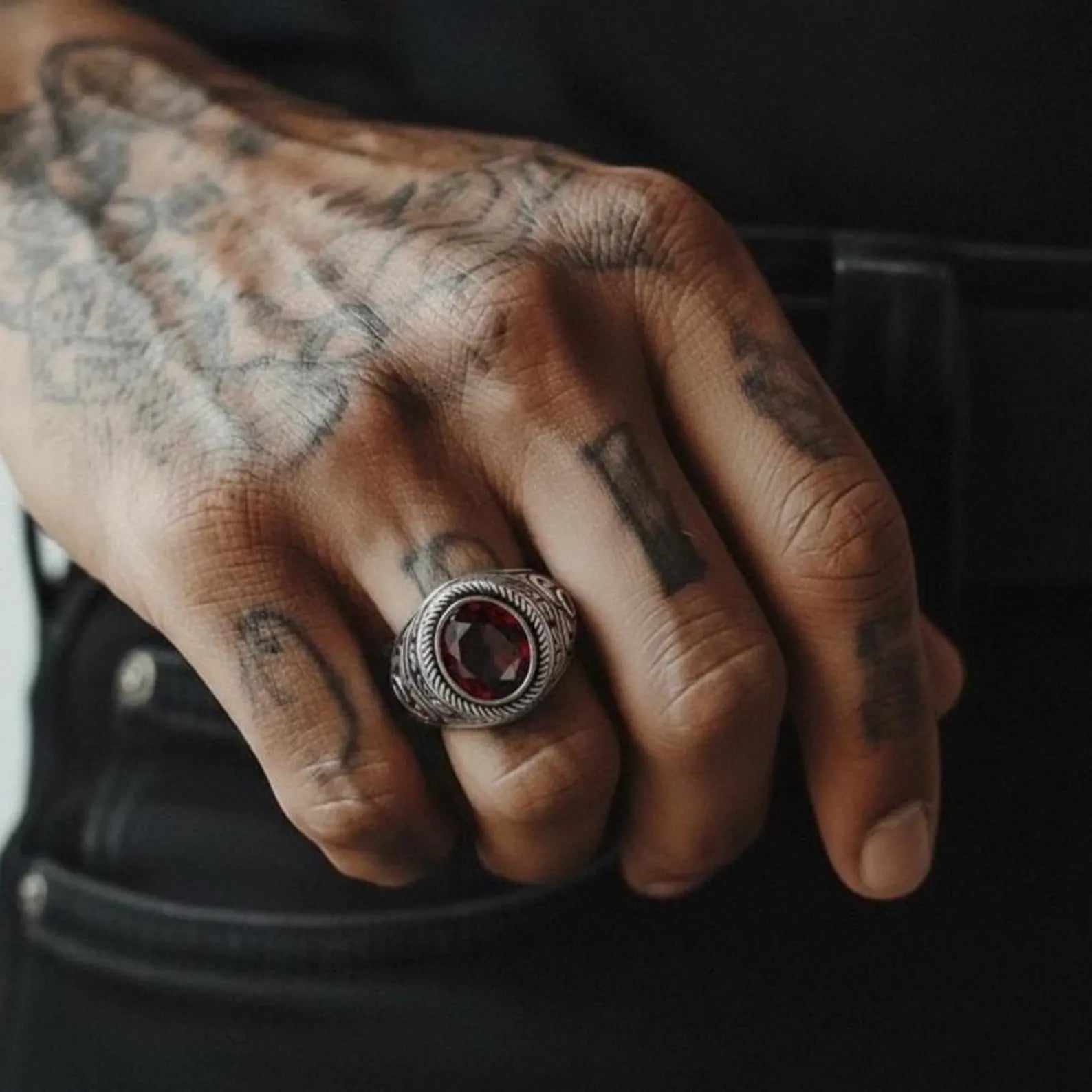 Personalized men’s garnet signet ring crafted in high-quality sterling silver, designed with a rich red garnet gemstone and detailed artisan silverwork for a strong masculine presence