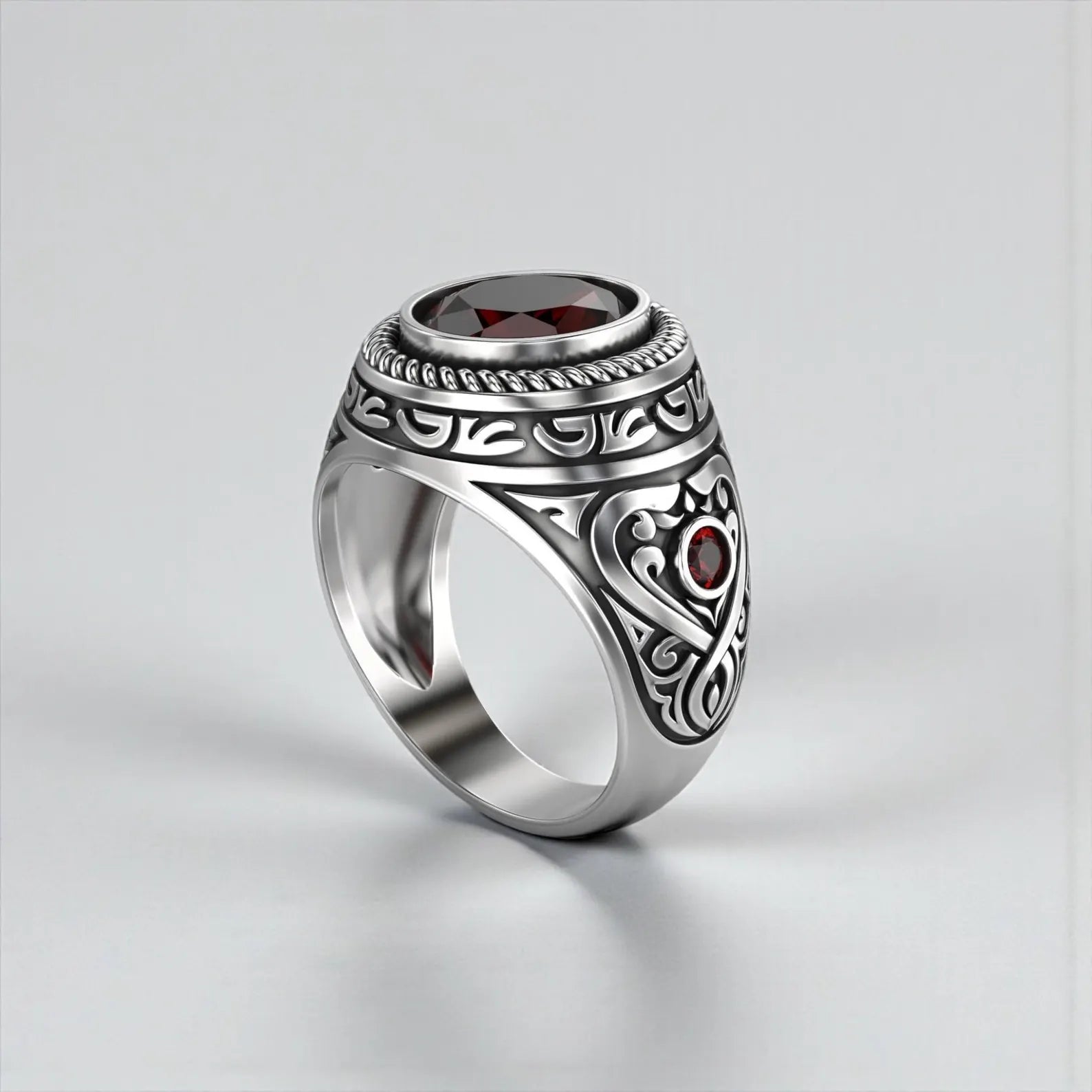 Men’s garnet ring designed with a thick solid silver band and intricate handcrafted details, offering a powerful and confident statement jewelry look