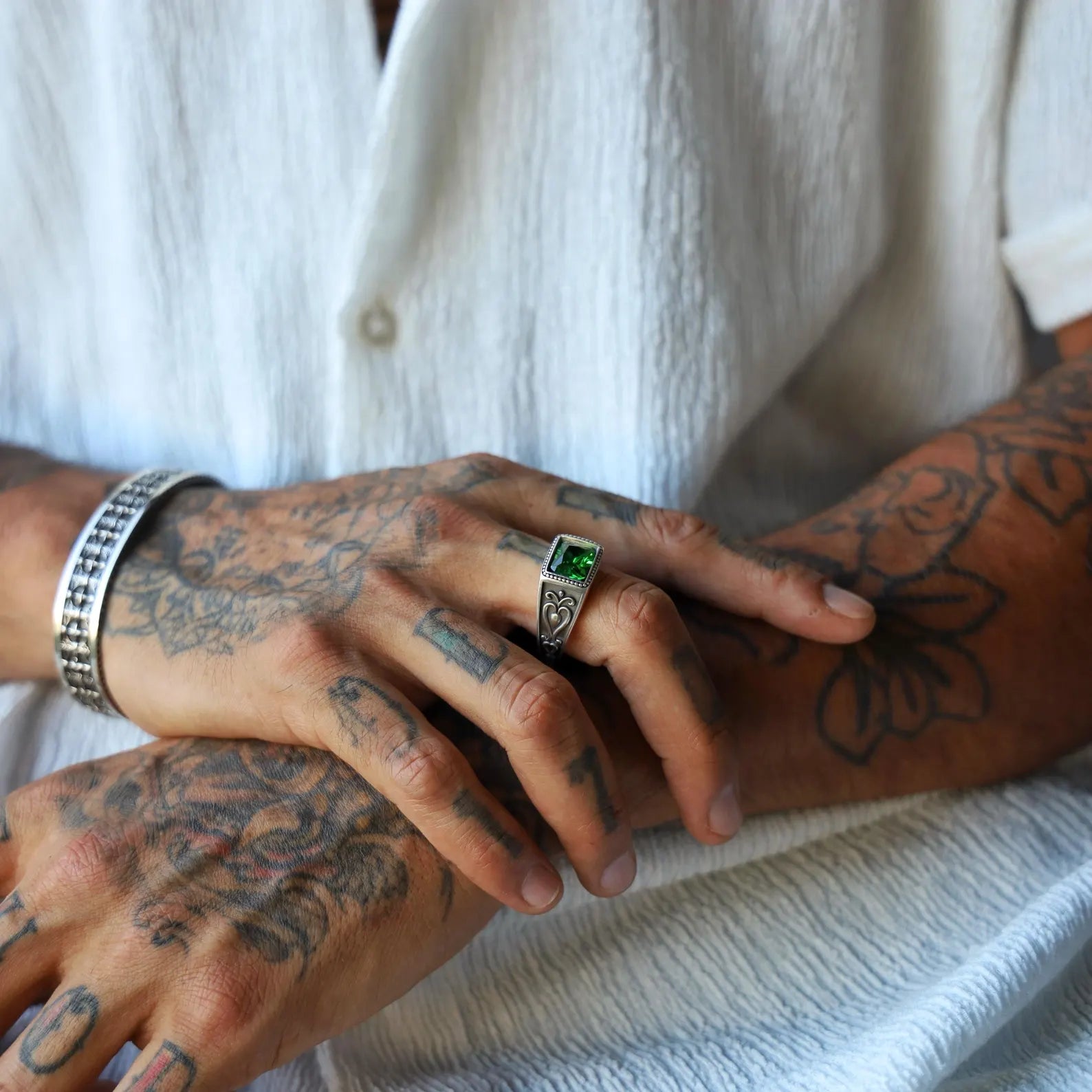 This handcrafted sterling silver ring for men features a brilliant emerald green gemstone in a bold square cut. With detailed gothic-style engravings on the band, it’s perfect for men who love unique, timeless, and expressive jewelry with a vintage or mysterious vibe.