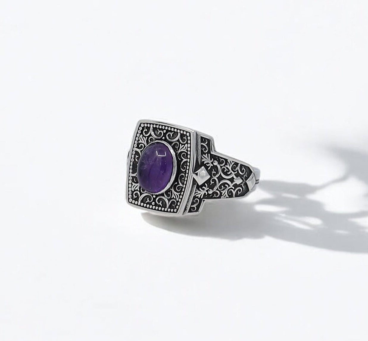A handcrafted sterling silver amethyst ring for men featuring a deep purple gemstone set in an intricately engraved vintage frame. This bold and bohemian-inspired piece of jewelry is designed to symbolize wisdom and individuality. Perfect for men who appreciate spiritual energy and elegant design in one unique accessory. A thoughtful choice for an anniversary or birthday gift with optional personalization.