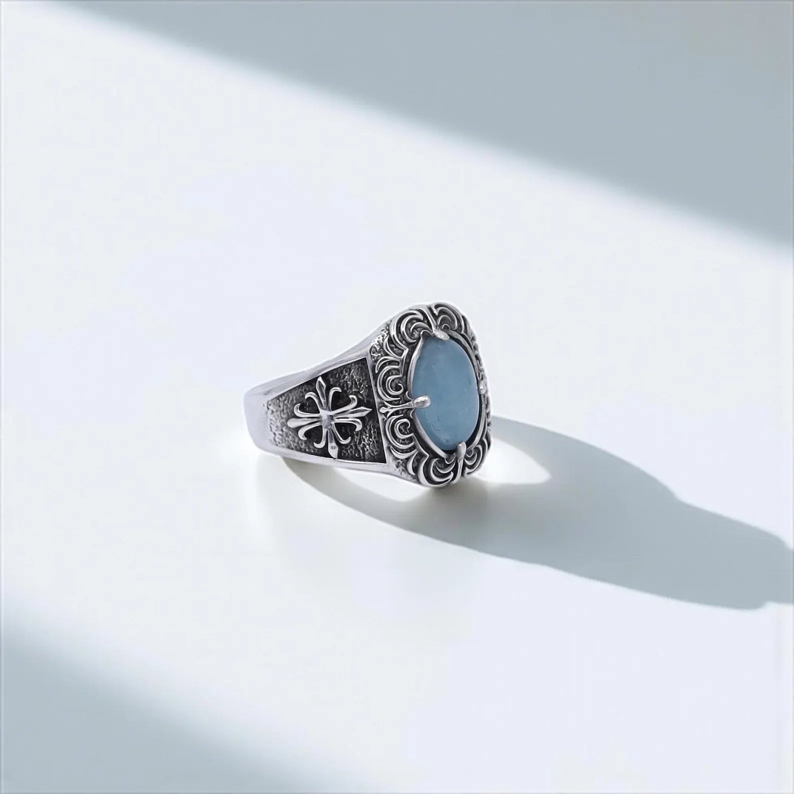 Handcrafted sterling silver men's ring featuring a bold aquamarine gemstone in a gothic medieval setting. A timeless statement piece with ornate side details and vintage cross motifs. Ideal gift for him on birthdays or anniversaries. Perfect for gothic style lovers and aquamarine birthstone jewelry collectors.