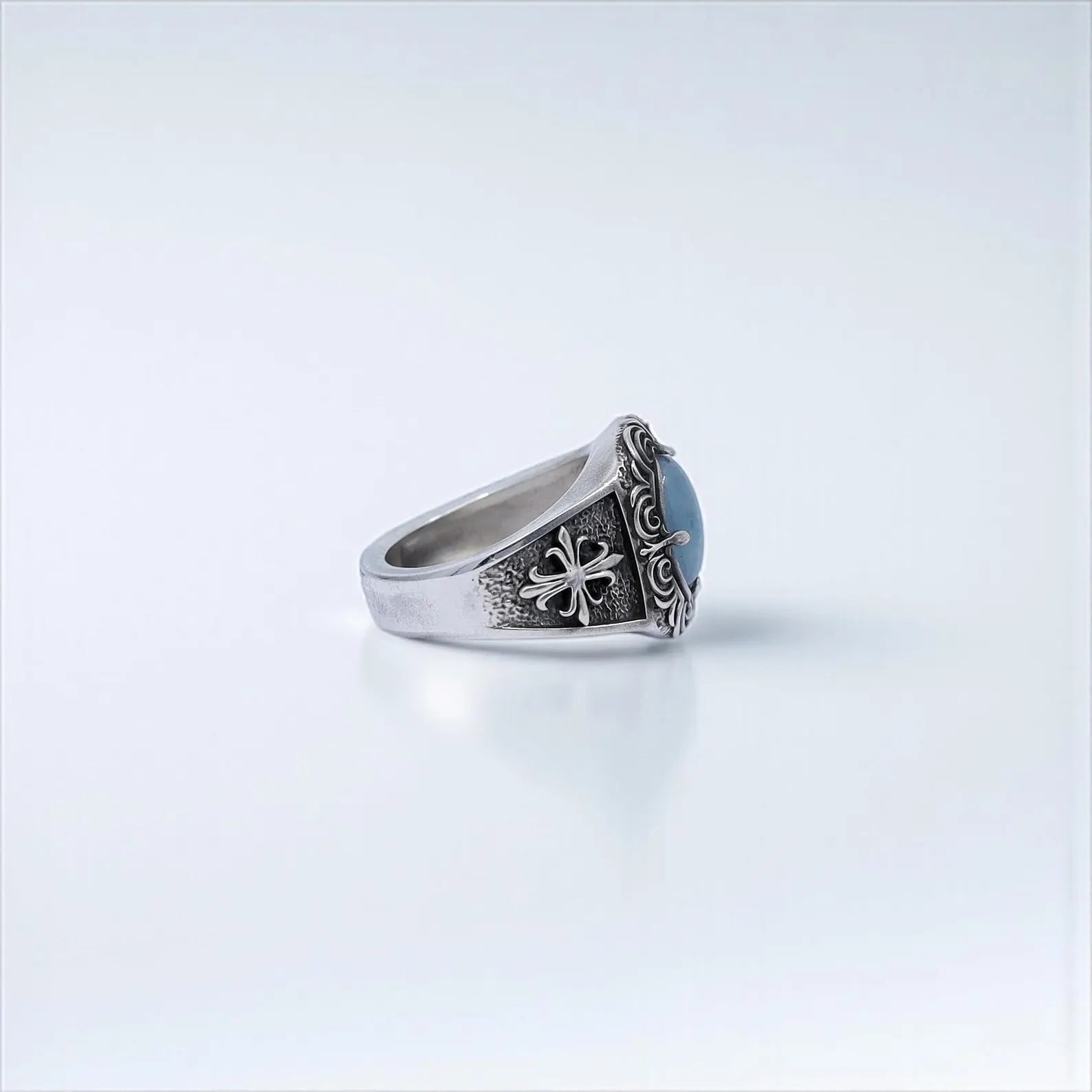 A handcrafted aquamarine men’s ring in gothic style, made with solid sterling silver and intricate medieval scroll details. An eye-catching piece of jewelry for men who embrace bold aesthetics. Works well on Instagram carousel posts or Pinterest collections for unique handmade gifts.