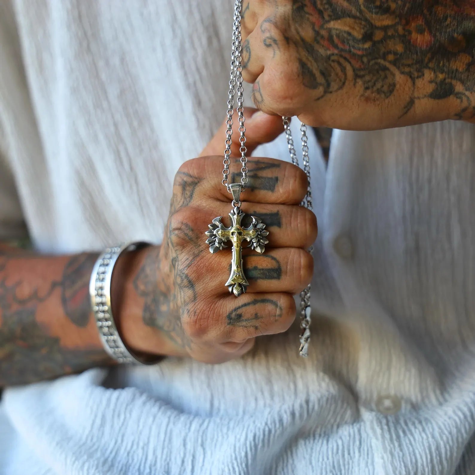 Unique gothic cross necklace featuring a winged skull in the center, handcrafted from 925 sterling silver and highlighted with gold-plated accents. A powerful symbol of strength, mortality, and transformation. Perfect for alternative fashion fans, rock culture lovers, or those seeking a bold gift with character.