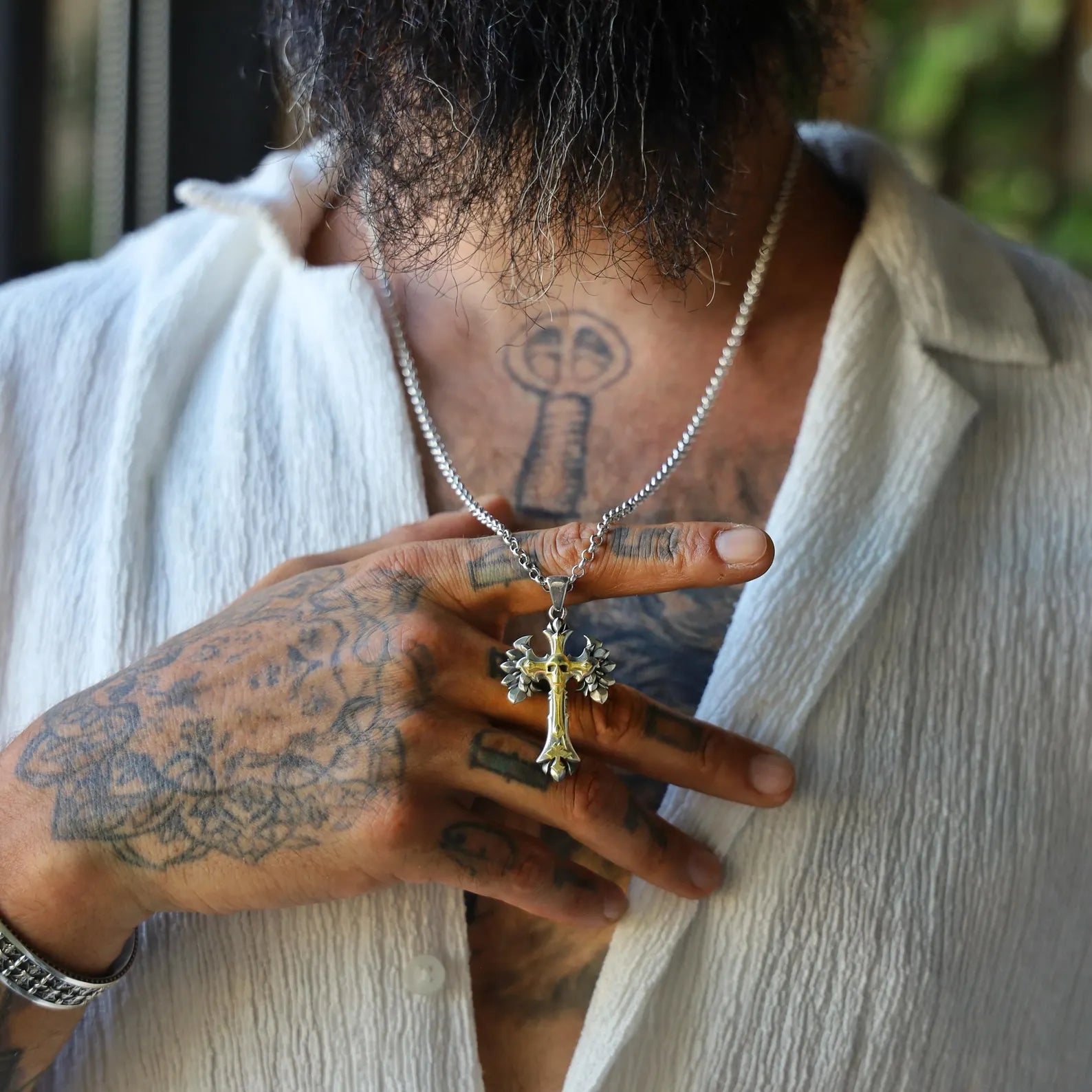 Artisan-crafted gothic pendant necklace with a striking combination of sterling silver and 18K gold plating. The skull cross design is enhanced by sharp, wing-like engravings, making it a perfect gift for gothic fashion lovers, musicians, or those who appreciate dark symbolic jewelry with a spiritual edge.