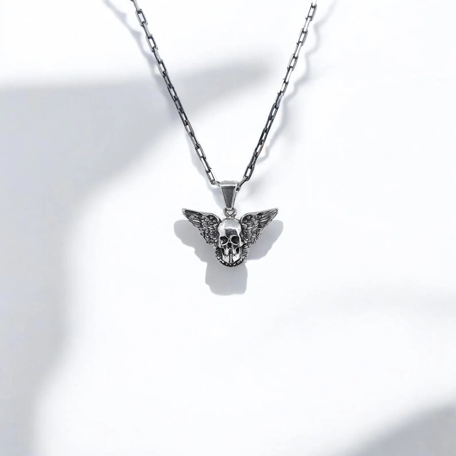 Crafted with precision and personality, this sterling silver winged skull pendant blends gothic elegance with rockstar attitude. The intricate skeletal details and sharp wing patterns embody themes of life, death, and transformation—common in gothic, occult, and alternative fashion aesthetics. Whether you're dressing up for a concert or adding an edge to your everyday look, this necklace is the perfect accessory for anyone drawn to powerful symbolism and artisan craftsmanship.