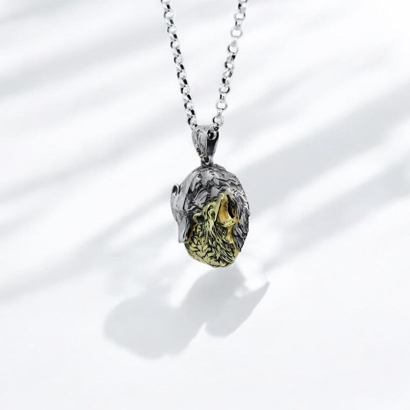 Yin Yang wolf necklace crafted in sterling silver and gold plating, representing the duality of life: peace and power, silence and strength. The detailed wolves howling and watching mirror each other’s energy, creating a harmonious spiritual balance. An ideal necklace for those who appreciate deeper meanings in jewelry and animal symbolism.