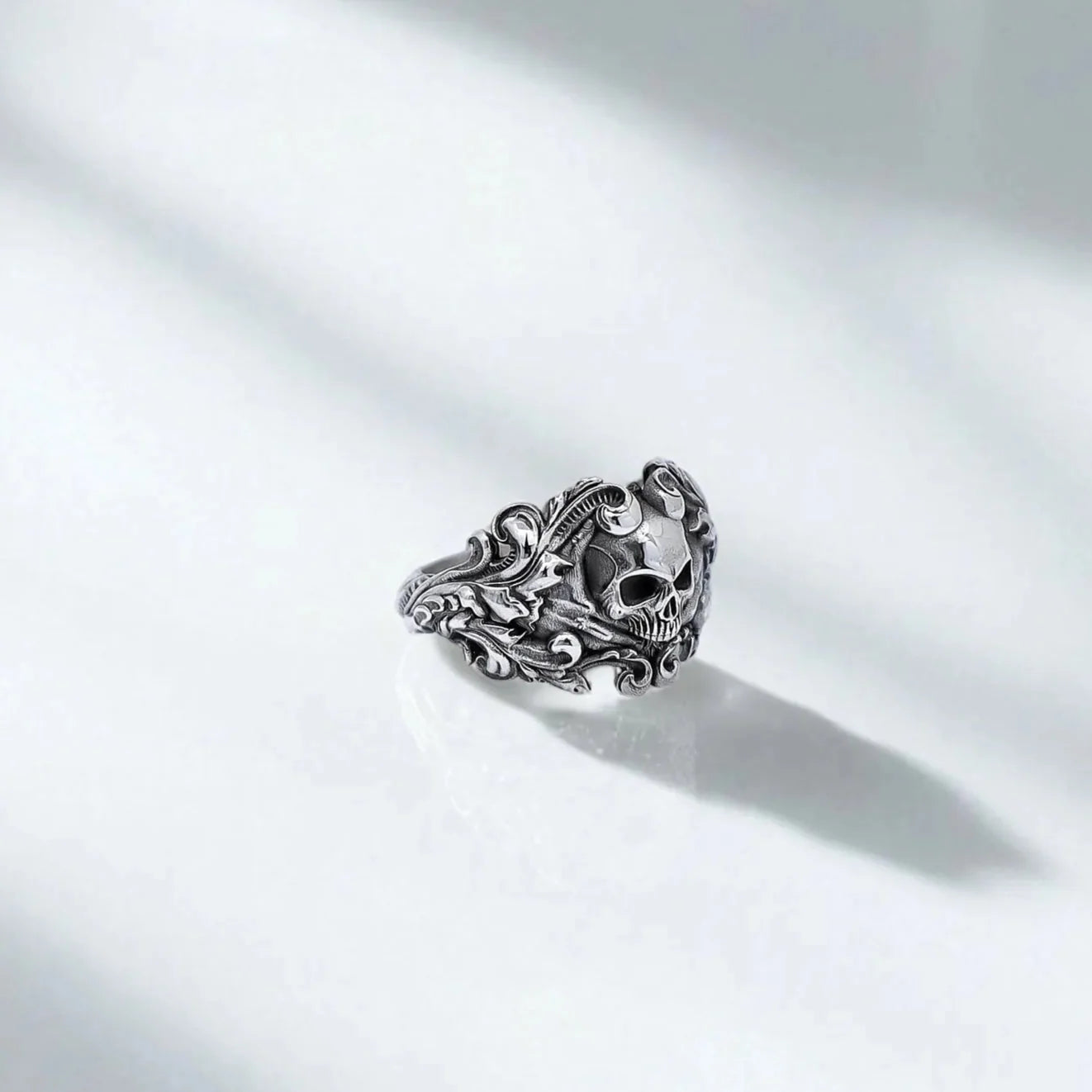 Handcrafted sterling silver skull ring featuring an intricately carved gothic skull surrounded by baroque scrollwork. A bold statement piece for bikers, punk rock lovers, and fans of Harley Davidson-style accessories.