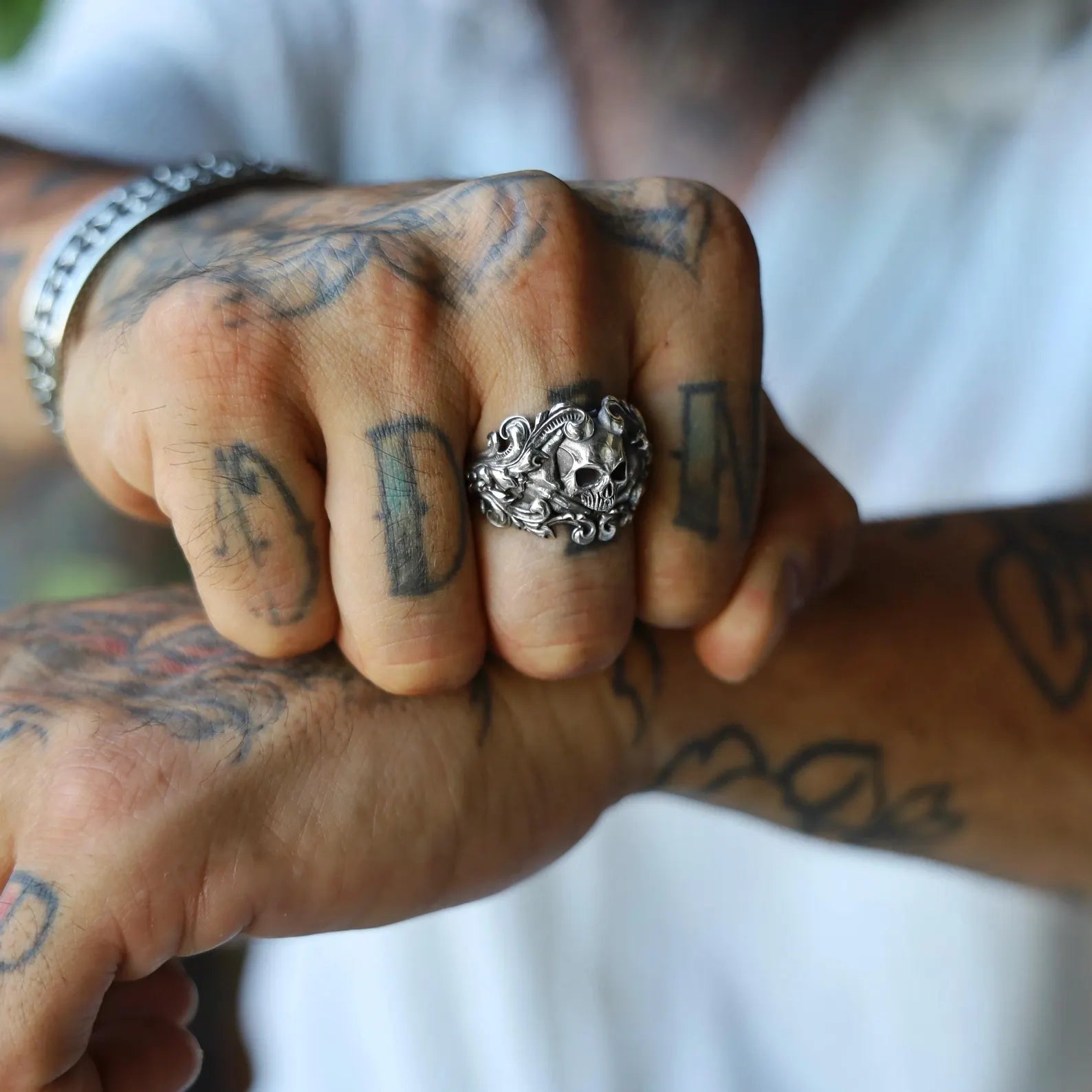 Gothic biker ring featuring a bold silver skull set in an ornate baroque frame, handcrafted for men who appreciate symbolic, edgy, and finely detailed jewelry with a dramatic and timeless presence.