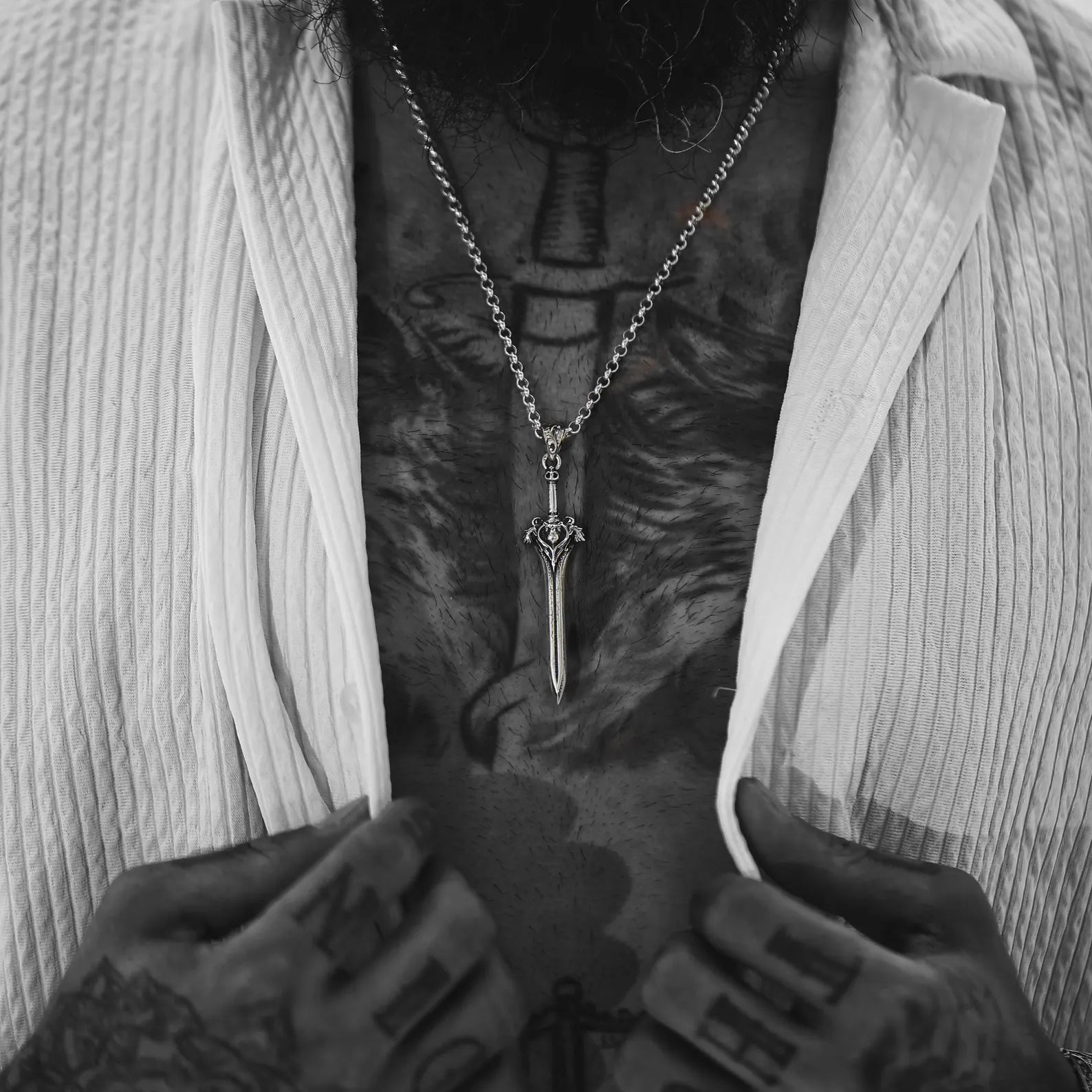 Bold silver necklace featuring a long medieval sword pendant with intricate lion and gothic designs. A handcrafted tribute to knight symbolism and masculine energy. Ideal for bikers, fantasy fans, and men who embrace their inner warrior.