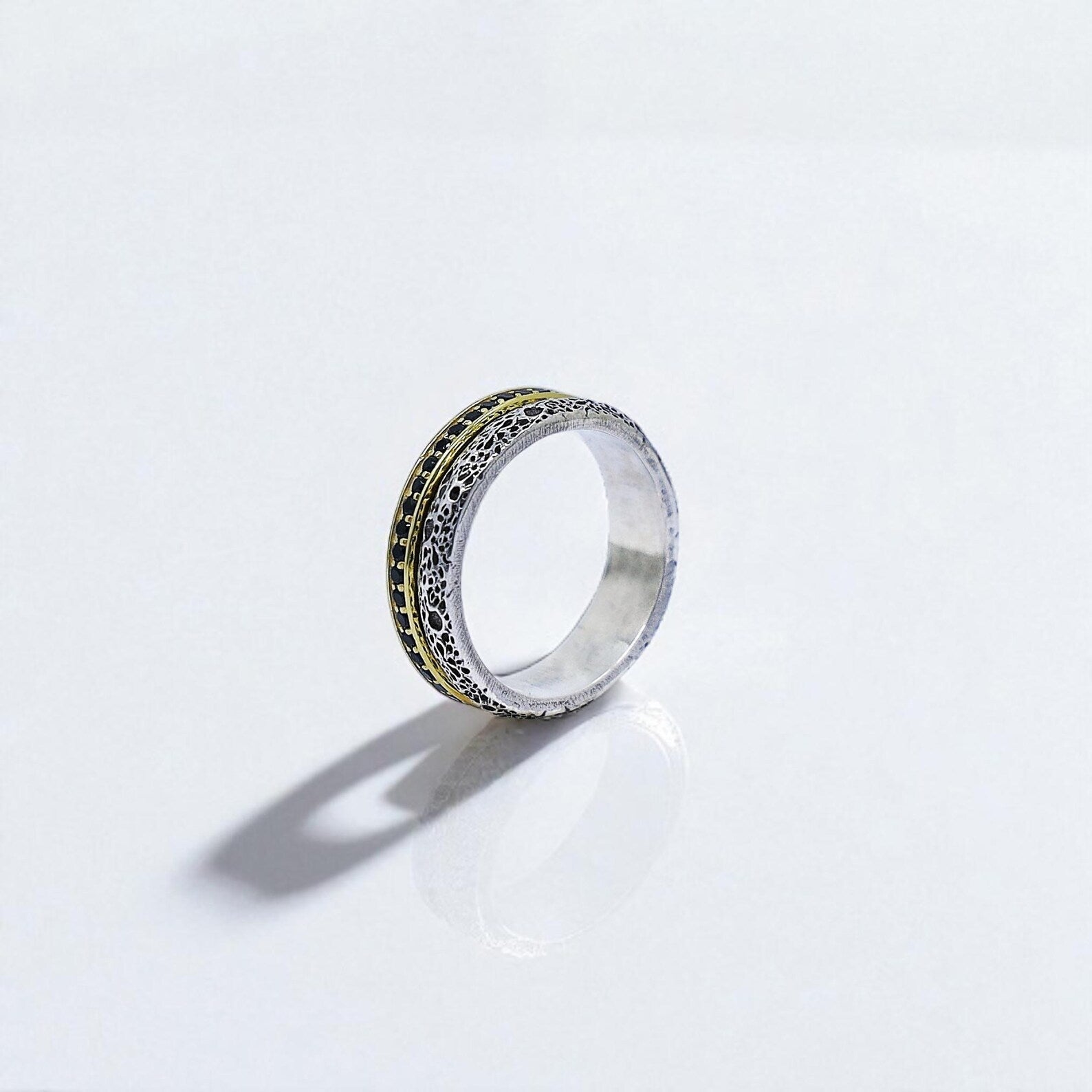 Front-facing view of a matching sterling silver couple ring set, featuring gold-plated braided edges and oxidized textured details. Each band includes a custom romantic engraving on the inside, making them perfect as wedding or anniversary rings for couples who value meaningful, handcrafted jewelry.