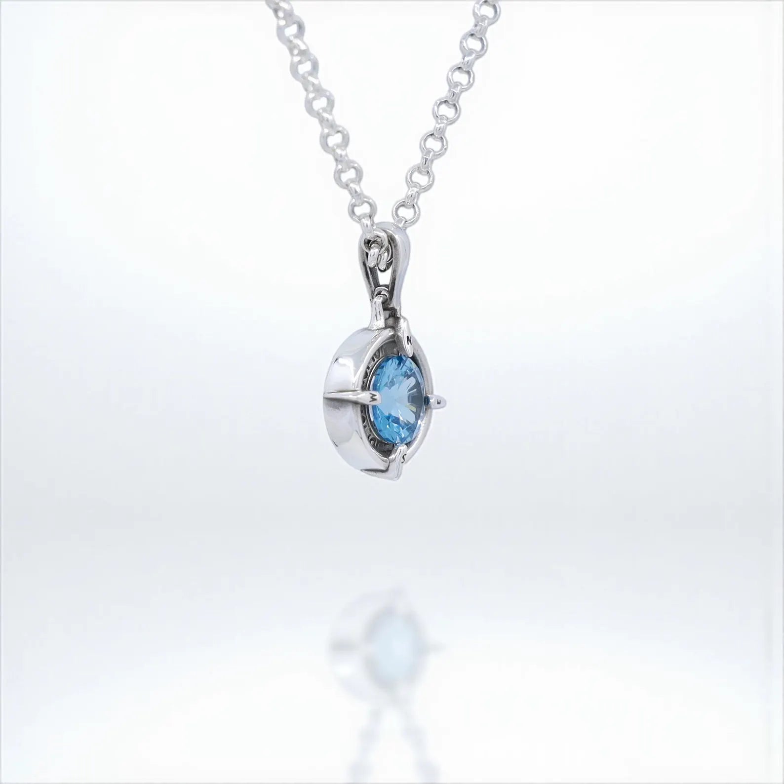 Elegant compass pendant handcrafted in sterling silver with a natural aquamarine gemstone. A unique March birthstone necklace representing direction, courage, and clarity. Perfect travel-inspired gift for boyfriend, girlfriend, or loved ones. This nautical jewelry piece blends artisan design with symbolic meaning, ideal for everyday wear.