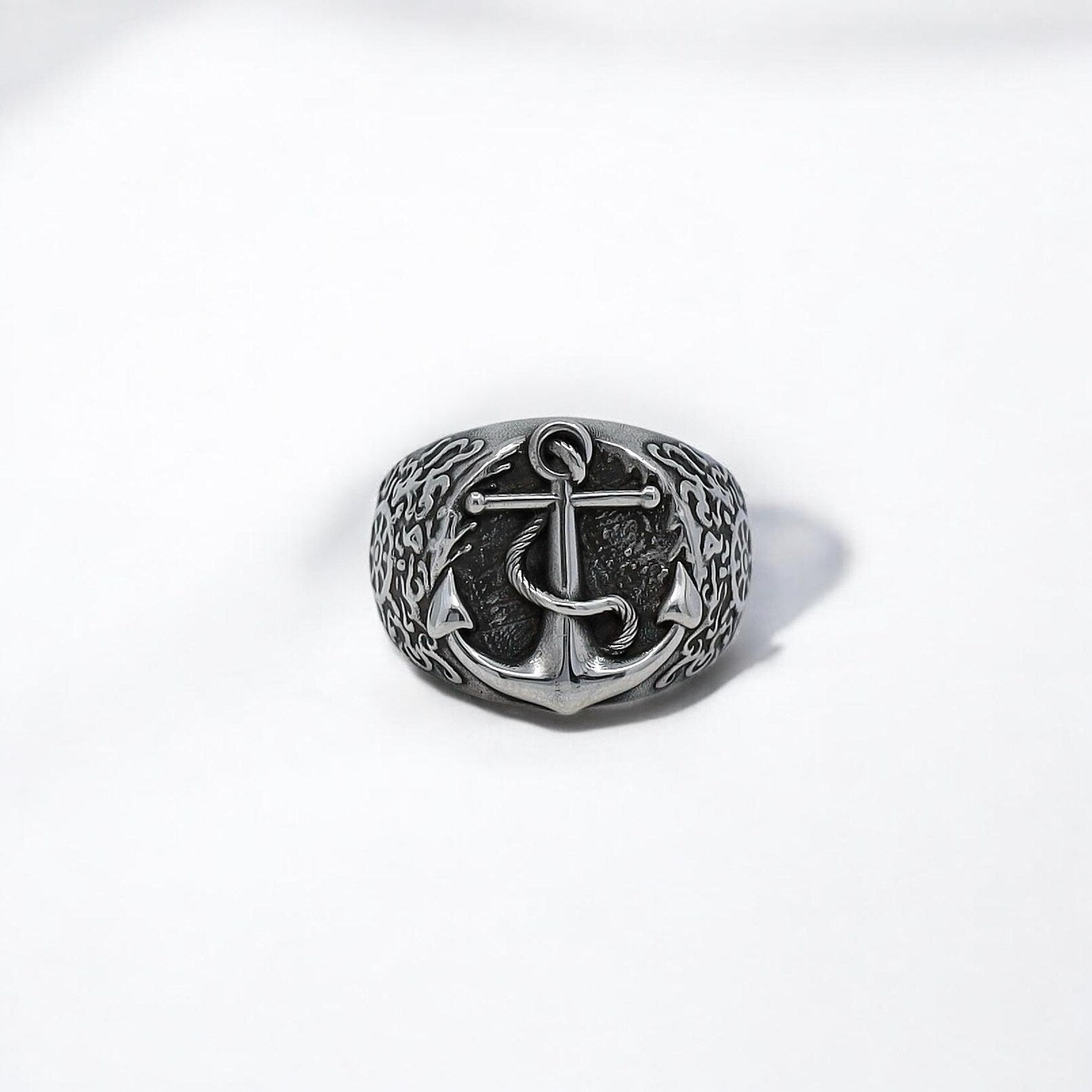 Close-up view of a unique silver sailor ring showcasing an intricately carved anchor design. The ring blends traditional maritime symbolism with contemporary masculine aesthetics. It serves as both a fashion accessory and a symbol of grounding and direction in life. Ideal for gifting to ocean explorers, adventurers, and men who express their identity through handcrafted gothic or nautical jewelry.