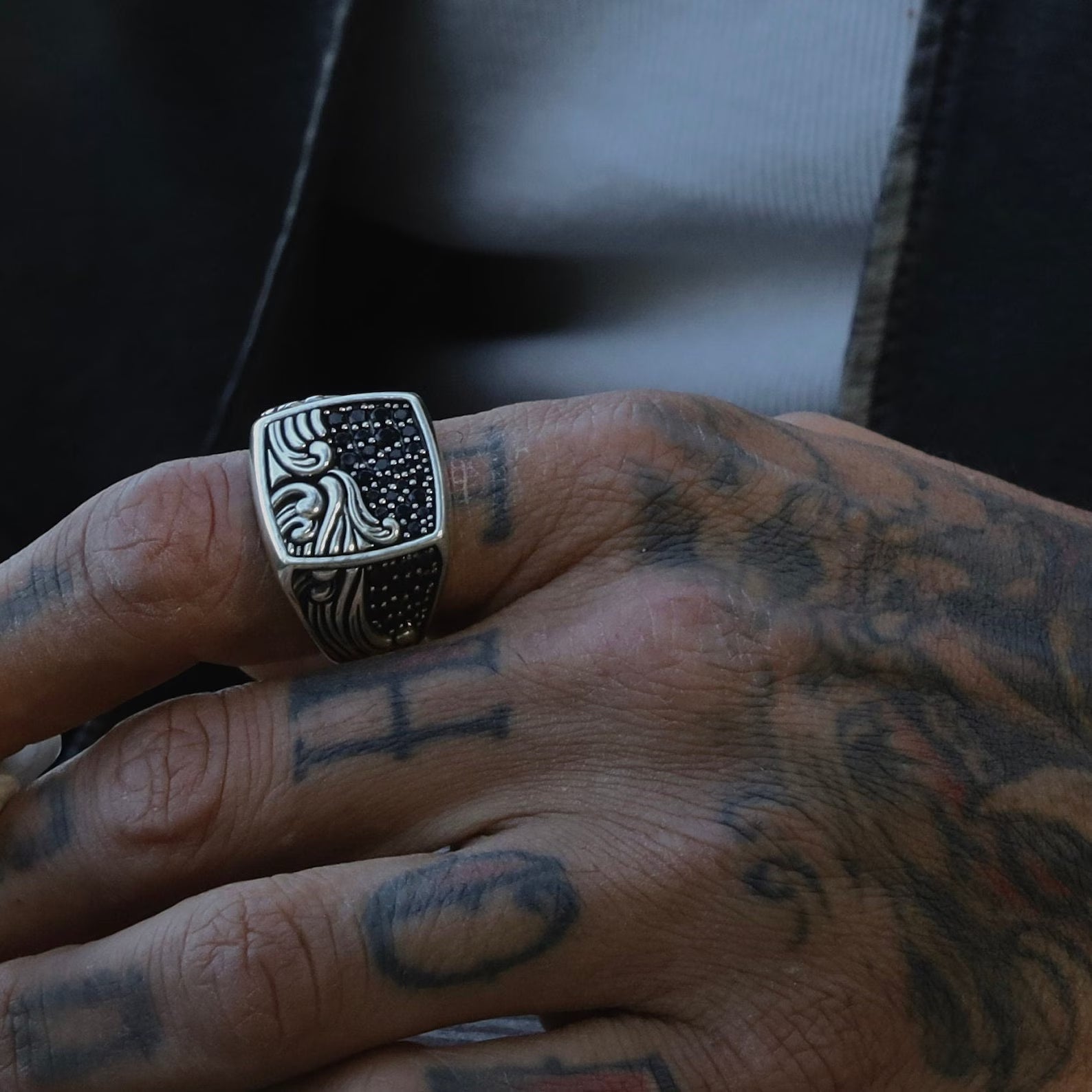 A unique silver signet ring designed with inspiration from the deep sea and the endless sky. The ring’s surface is carved with intricate ocean wave motifs flowing beneath a dotted night sky, symbolizing nature’s rhythm and tranquility. With a diameter of 23.1mm and height of 23.9mm, this piece blends statement style with wearable comfort for both men and women.
