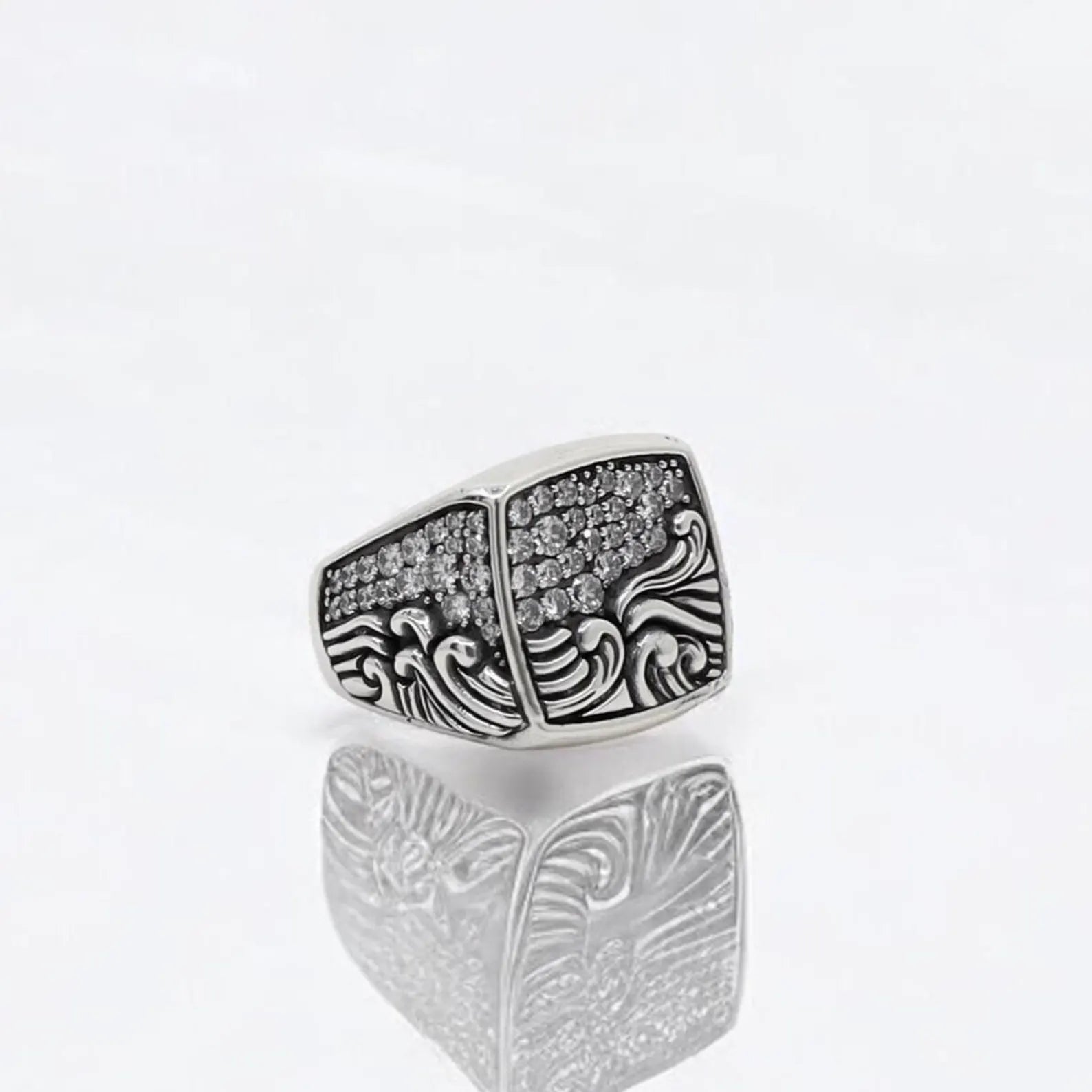 This handcrafted sterling silver ocean wave ring for men features an intricate nautical design with flowing wave engravings and a surface set with dazzling zircon stones. Symbolizing the strength and calm of the sea, this statement ring reflects the wearer’s connection to freedom, depth, and movement. Whether as a gift for a sailor, adventurer, or sea lover, this ring is a unique and lasting piece of maritime-inspired jewelry.
