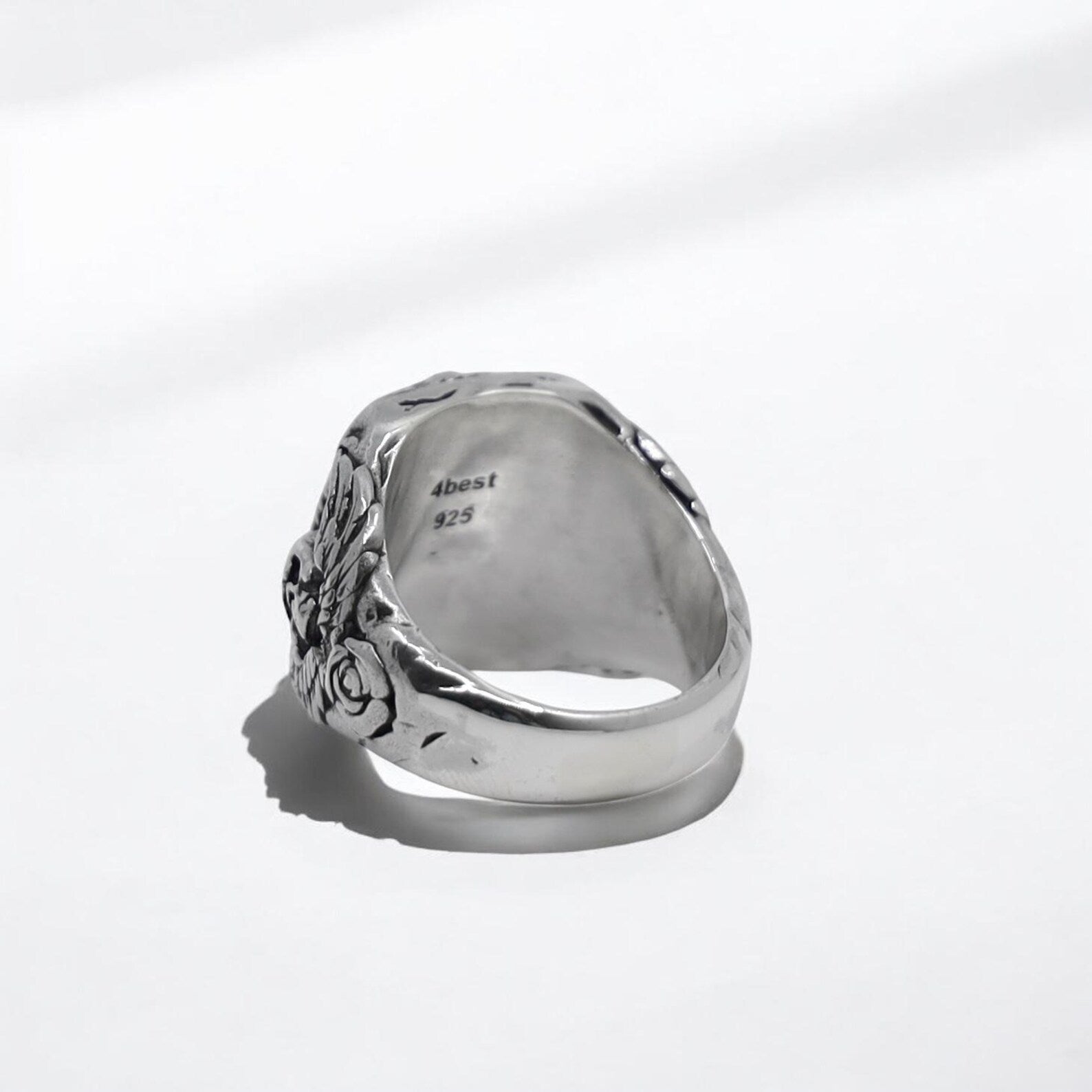 A bold silver ring with a shimmering labradorite gemstone at the center, surrounded by intricate skull and feather designs. This handcrafted men’s accessory combines elegance and grit, perfect for bikers, rockers, or anyone drawn to unique gothic jewelry.