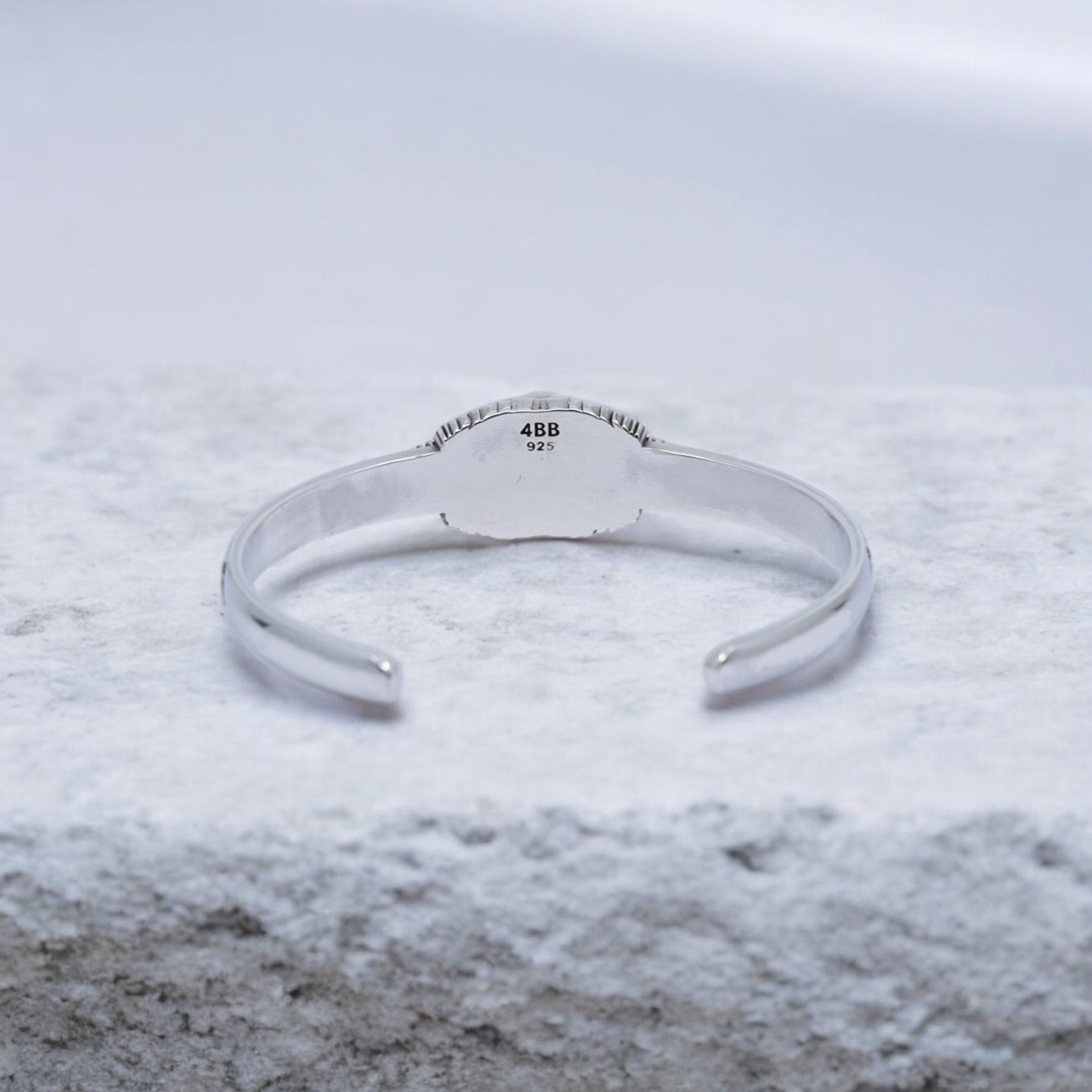 High-quality photo of a black onyx silver cuff bracelet, handmade with gothic skull details. Perfectly balanced between rugged and refined, this bracelet expresses strength and individuality for confident modern men.