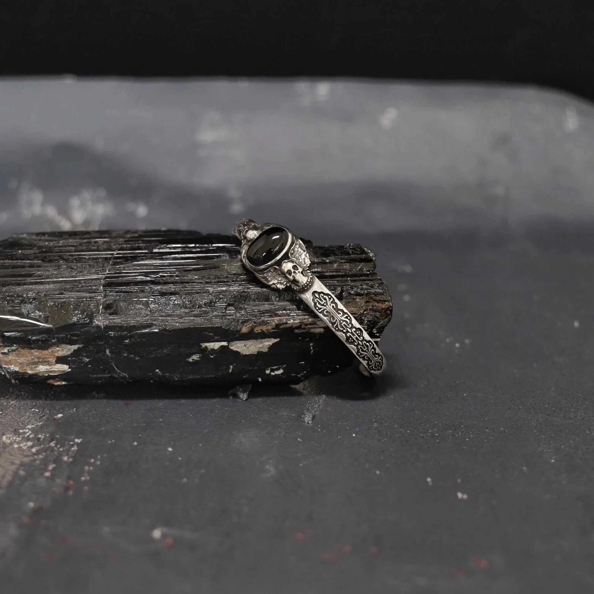 Luxury sterling silver skull bracelet with onyx stone, handcrafted to perfection. Each detail, from the oxidized textures to the polished gemstone, reflects premium artistry — ideal for collectors of dark silver men’s jewelry.