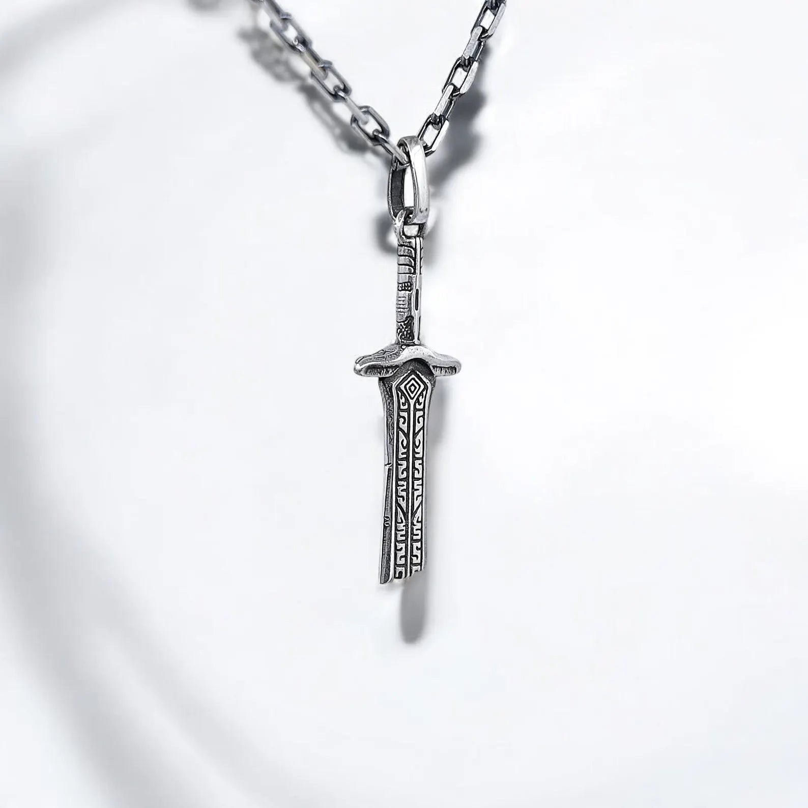Silver sword pendant necklace exuding Gothic energy and warrior spirit, handcrafted with precise engraving and medieval motifs, perfect for expressing individuality, personal symbolism, or devotion to historical mythology.