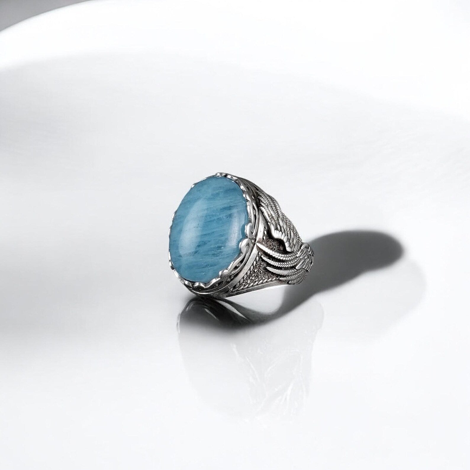 An elegant and symbolic aquamarine statement ring made from solid 925 silver, designed with an organic claw motif embracing a large natural blue stone. This ring reflects a perfect harmony of gothic and bohemian design, offering both style and deep emotional significance for adventurous souls and collectors of mystical jewelry.