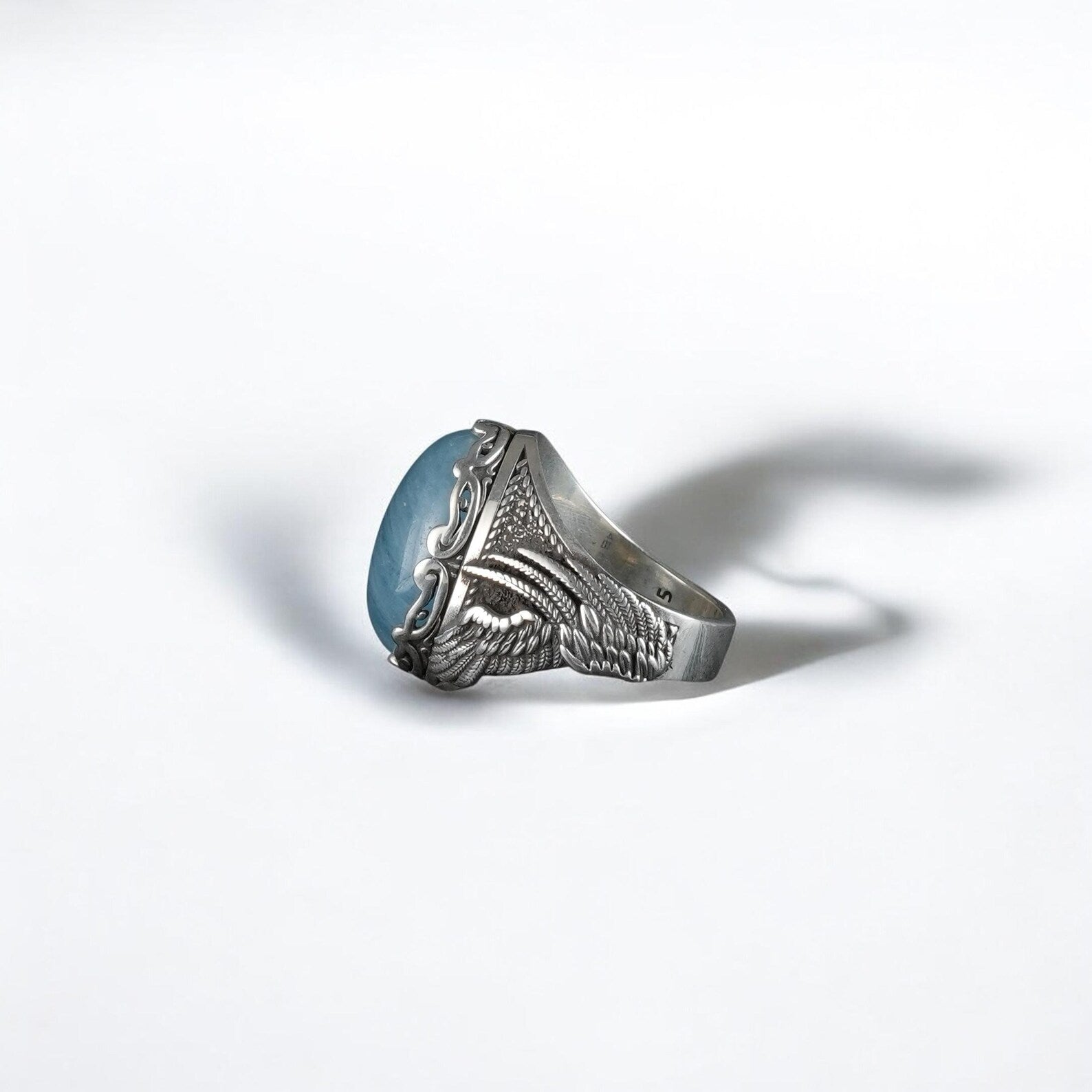 A bold men’s ring crafted with a genuine aquamarine center stone and detailed gothic-style silverwork, handcrafted to deliver lasting quality and timeless symbolism. Representing tranquility and spiritual clarity, this artisan piece makes a unique anniversary or Father’s Day gift for a man with refined yet daring style.