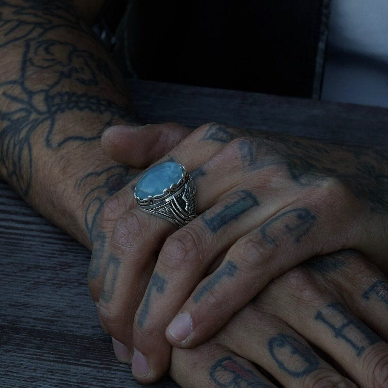 This handcrafted men’s aquamarine ring is created from 925 sterling silver and features an ornate, gothic wing motif that secures a natural blue gemstone. Ideal for everyday wear or ceremonial occasions, the ring captures the essence of nature, elegance, and resilience, making it a standout piece in any collection.