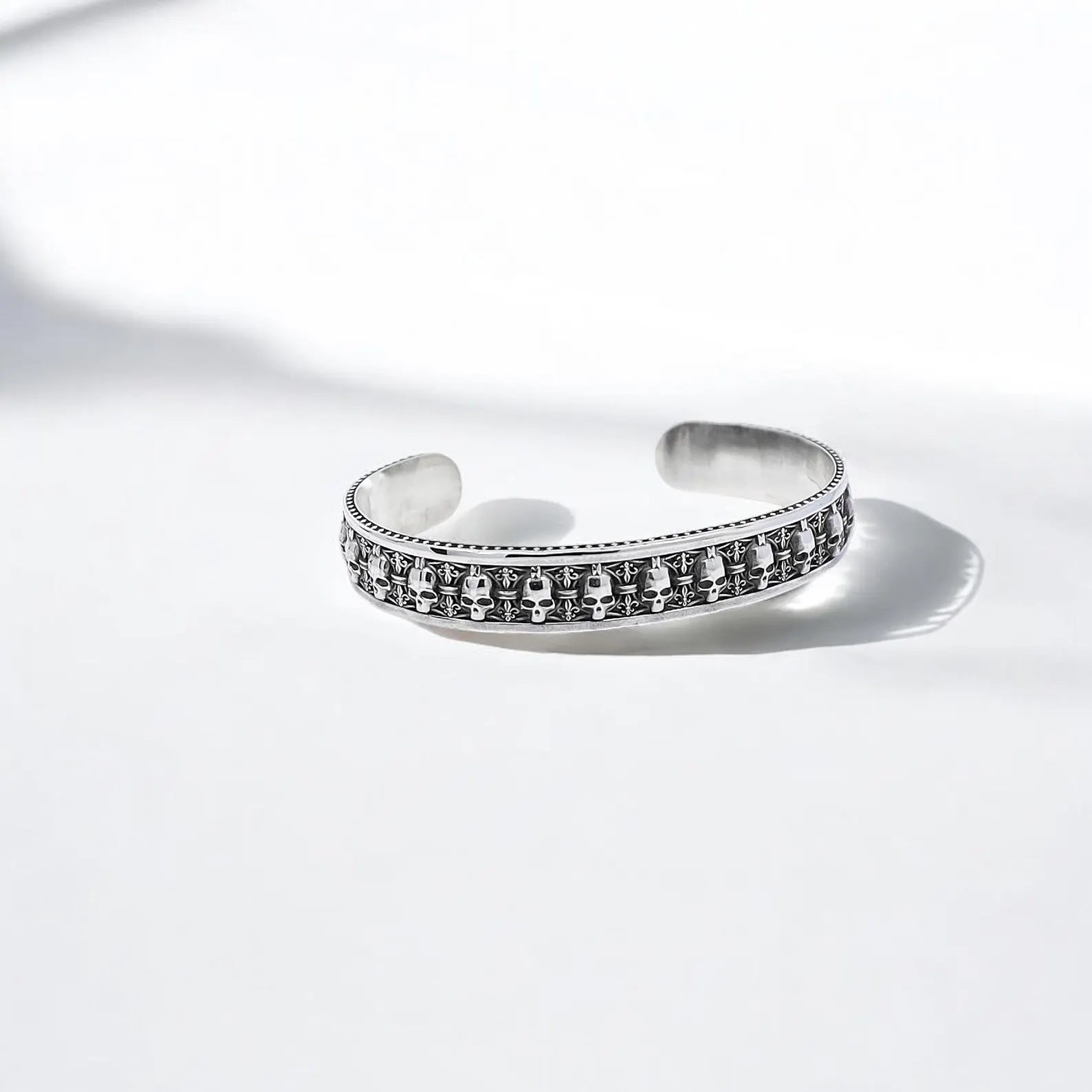 This silver skull cuff bracelet showcases masterful artisan detailing with a dark, oxidized finish that highlights the menacing skull engravings. With a 160mm diameter and 12mm thickness, it’s a solid, high-quality piece that enhances gothic, medieval, and biker-inspired outfits with a distinctive, rebellious flair.