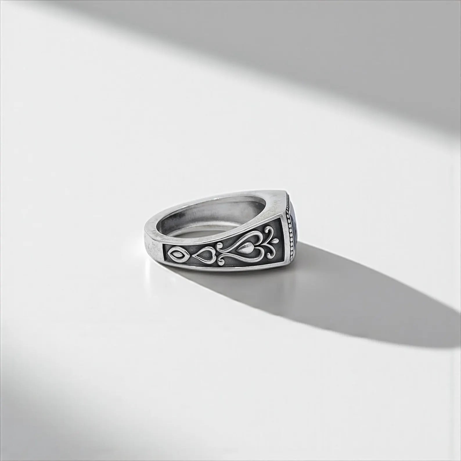 Artisan-crafted gothic ring featuring a rectangular sapphire blue zircon set in a sterling silver band, offering a unique mix of boho charm and vintage sophistication for modern men.