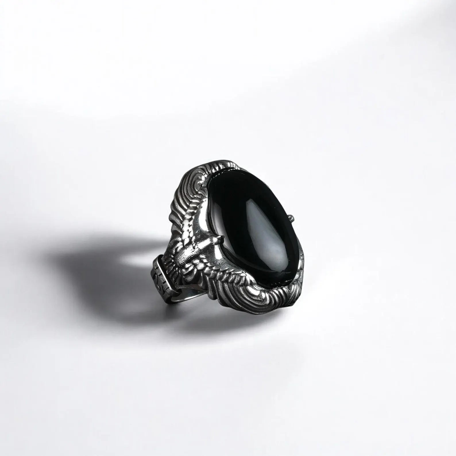 A bold handcrafted men’s ring made from 925 sterling silver, featuring a polished black onyx gemstone embraced by detailed eagle claw designs, symbolizing power, freedom, and inner strength. This statement piece is ideal for gothic style lovers and men who wear their identity through powerful jewelry.