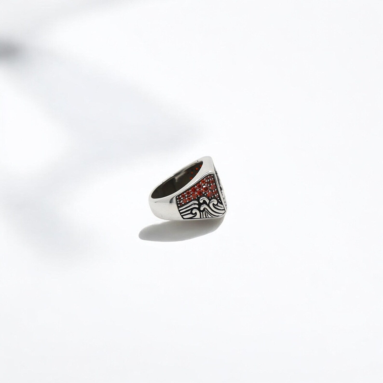 Nautical birthstone ring in sterling silver with a radiant ruby red zircon, evoking the essence of the sea. Designed for men who love distinctive, handcrafted jewelry with symbolic meaning, this ring is a great addition to beachwear and coastal lifestyle fashion.
