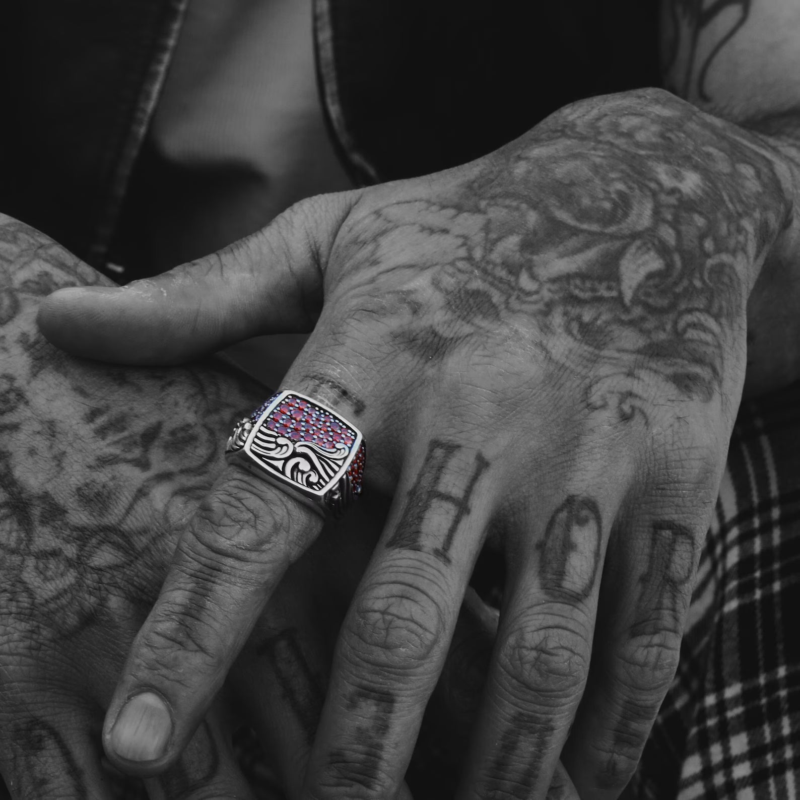 Close-up shot showcasing the vibrant red ruby gemstone set against a detailed wave motif band made of 925K sterling silver. Perfect for shoppers looking for ocean-themed jewelry for men or anniversary gifts that symbolize passion, nature, and adventure.