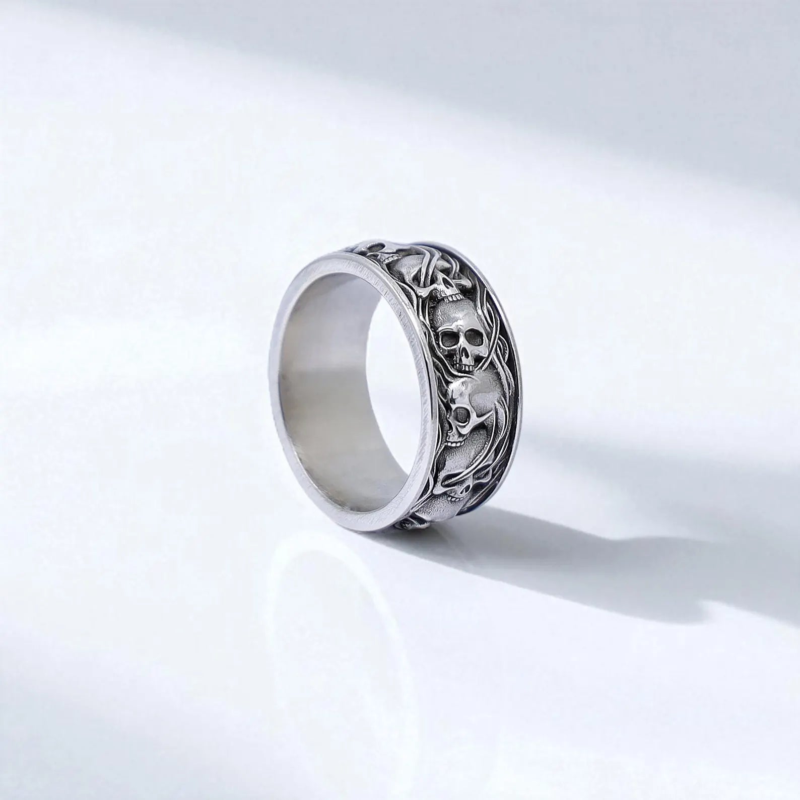 Handcrafted men’s skull ring made from solid 925 sterling silver, featuring a bold band design with deeply engraved gothic skull motifs. This ring blends biker aesthetics and dark elegance, making it a perfect statement piece for alternative fashion lovers. A unique and meaningful gift for him—ideal for anniversaries, birthdays, or gothic-style weddings.