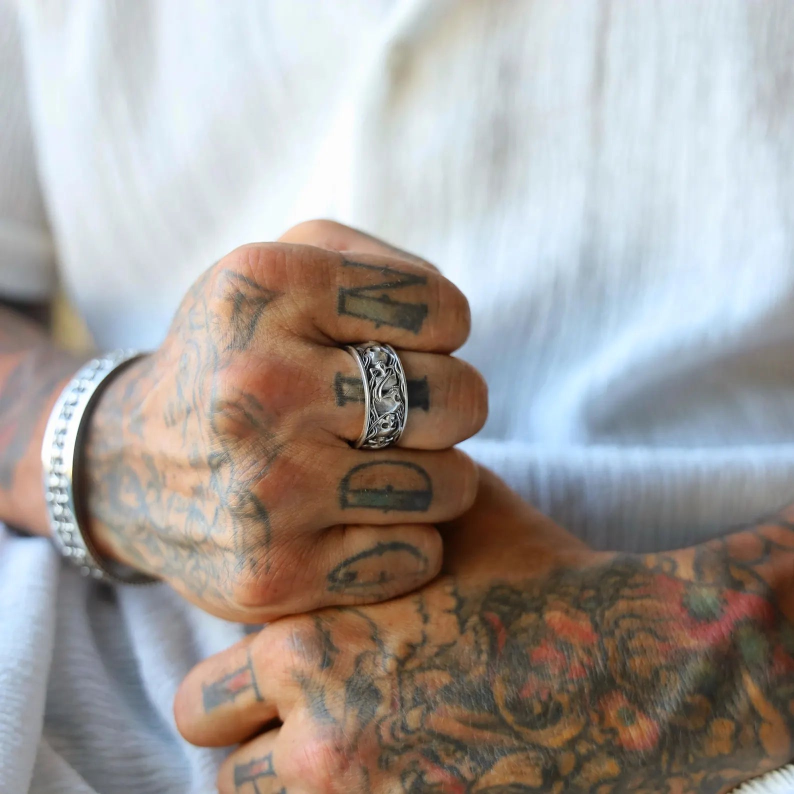 Sterling silver gothic skull ring for men, designed with a chunky band that’s densely detailed with sculpted bones and skull patterns. This piece is perfect for gothic weddings, motorcycle riders, or anyone who embraces dark fashion and handcrafted elegance. A rugged and refined piece of jewelry.