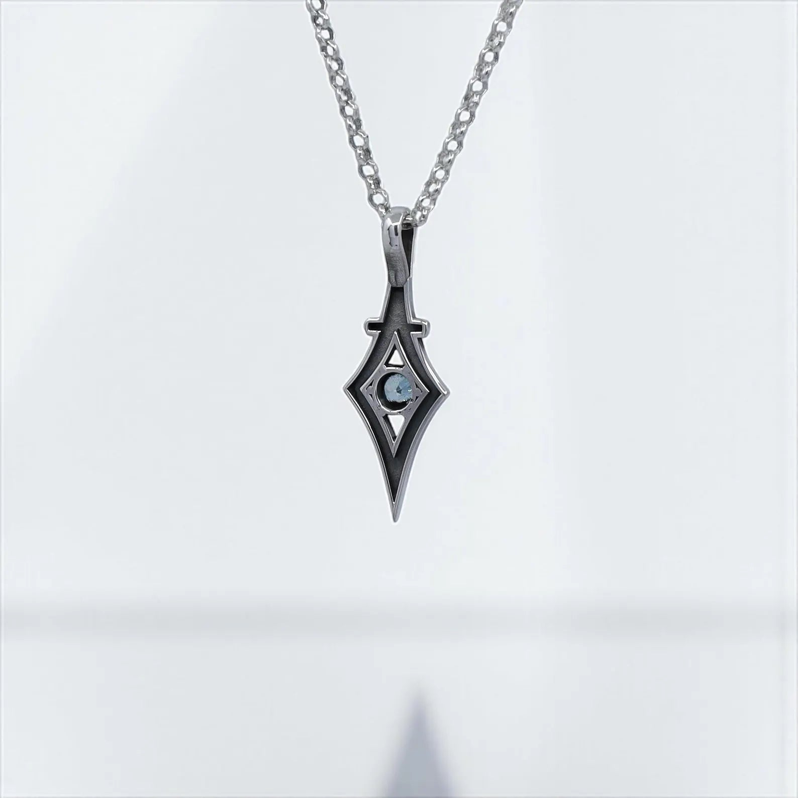 Sterling silver gothic pendant necklace handcrafted with a shimmering aquamarine gemstone. This minimalist jewelry design represents clarity, protection, and bold style. Perfect as a March birthstone gift for women who value unique, artisan-made jewelry. A versatile piece for both casual and formal outfits.