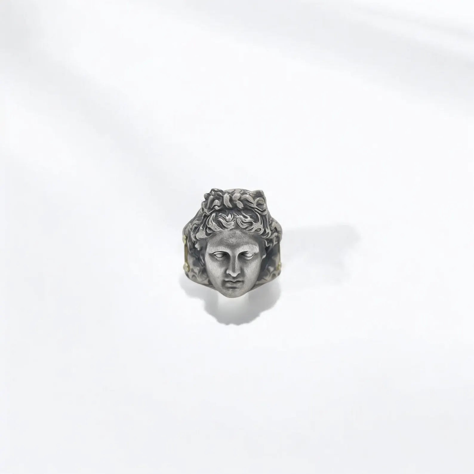 This silver and gold Apollo god ring captures the mystique of Greek mythology with detailed engraving and a powerful, regal profile. Handcrafted with precision, the ring pays tribute to the divine artistry of Apollo, making it an ideal anniversary or birthday gift for lovers of mythology and symbolic jewelry.