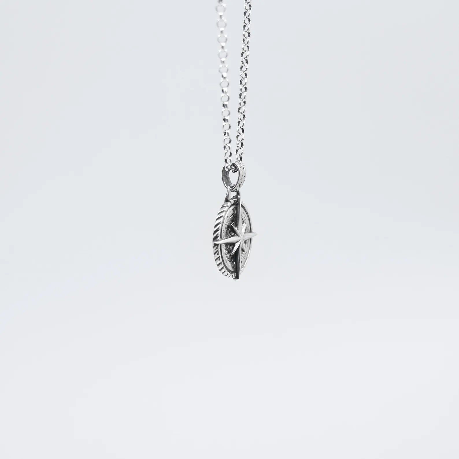 Bold and stylish silver compass necklace for men, showcasing an intricate north star design with ocean-inspired elegance. Handcrafted with precision and paired with a sturdy silver chain, this necklace is the perfect blend of rugged charm and sophistication. A meaningful maritime jewelry gift for boyfriends, husbands, fathers, and travelers seeking direction and purpose.