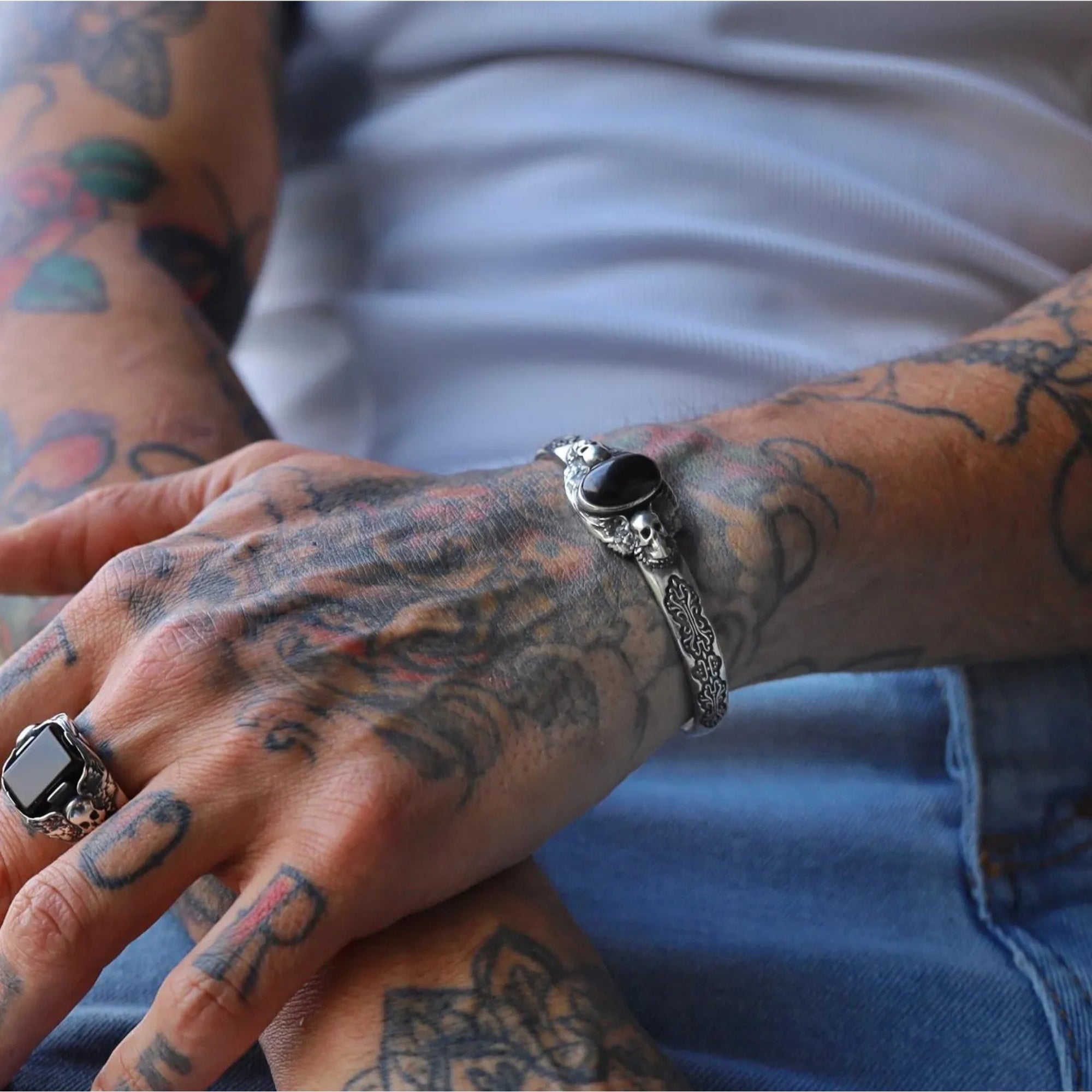 Oxidized silver bracelet with gothic skull engravings and a natural black onyx gemstone, handcrafted for men. Its unique blend of luxury and rebellion makes it perfect for gothic, biker, or medieval-inspired fashion styles.