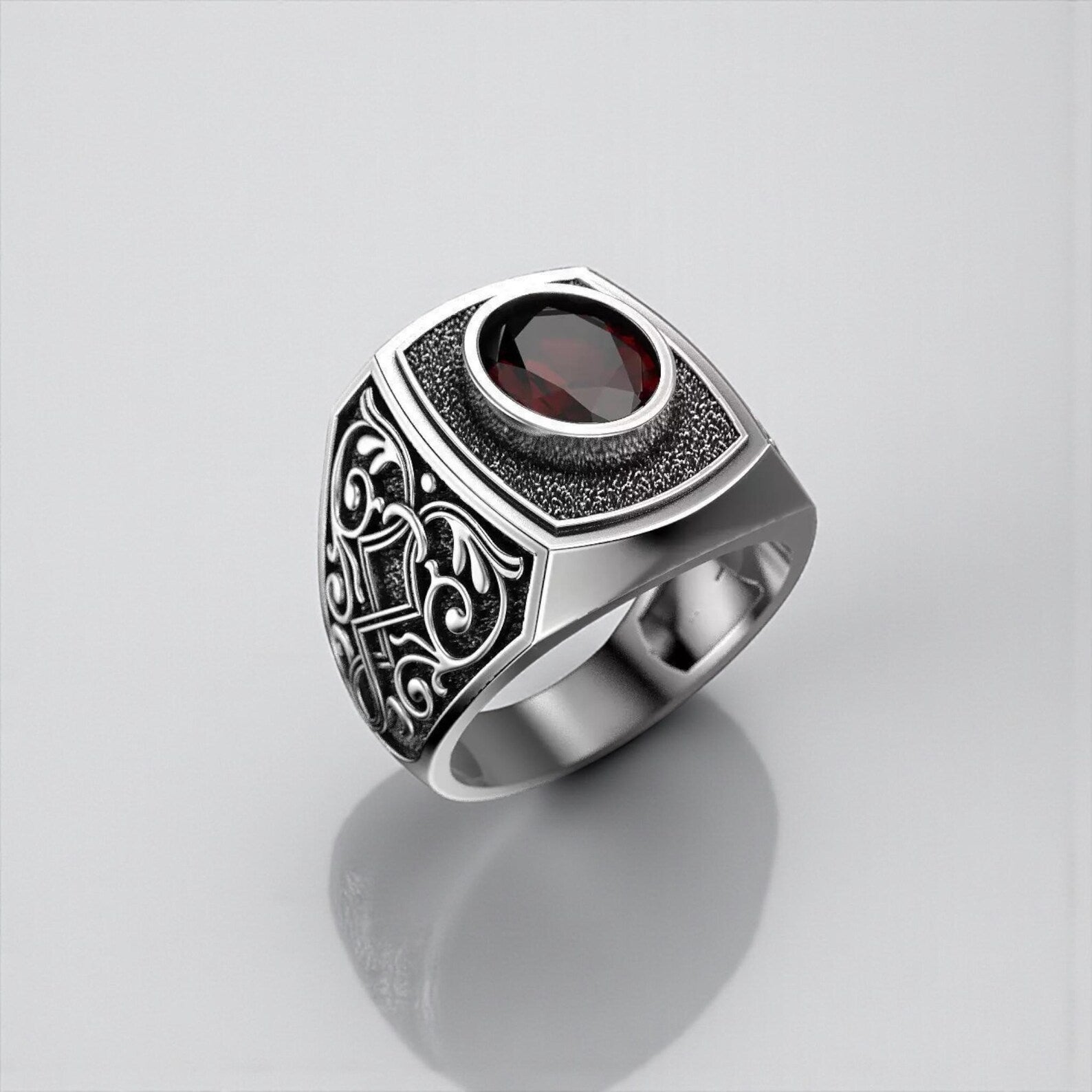 Gothic red garnet signet ring for men handcrafted from 925 sterling silver, featuring a deep red birthstone gemstone and dark aesthetic gothic engravings