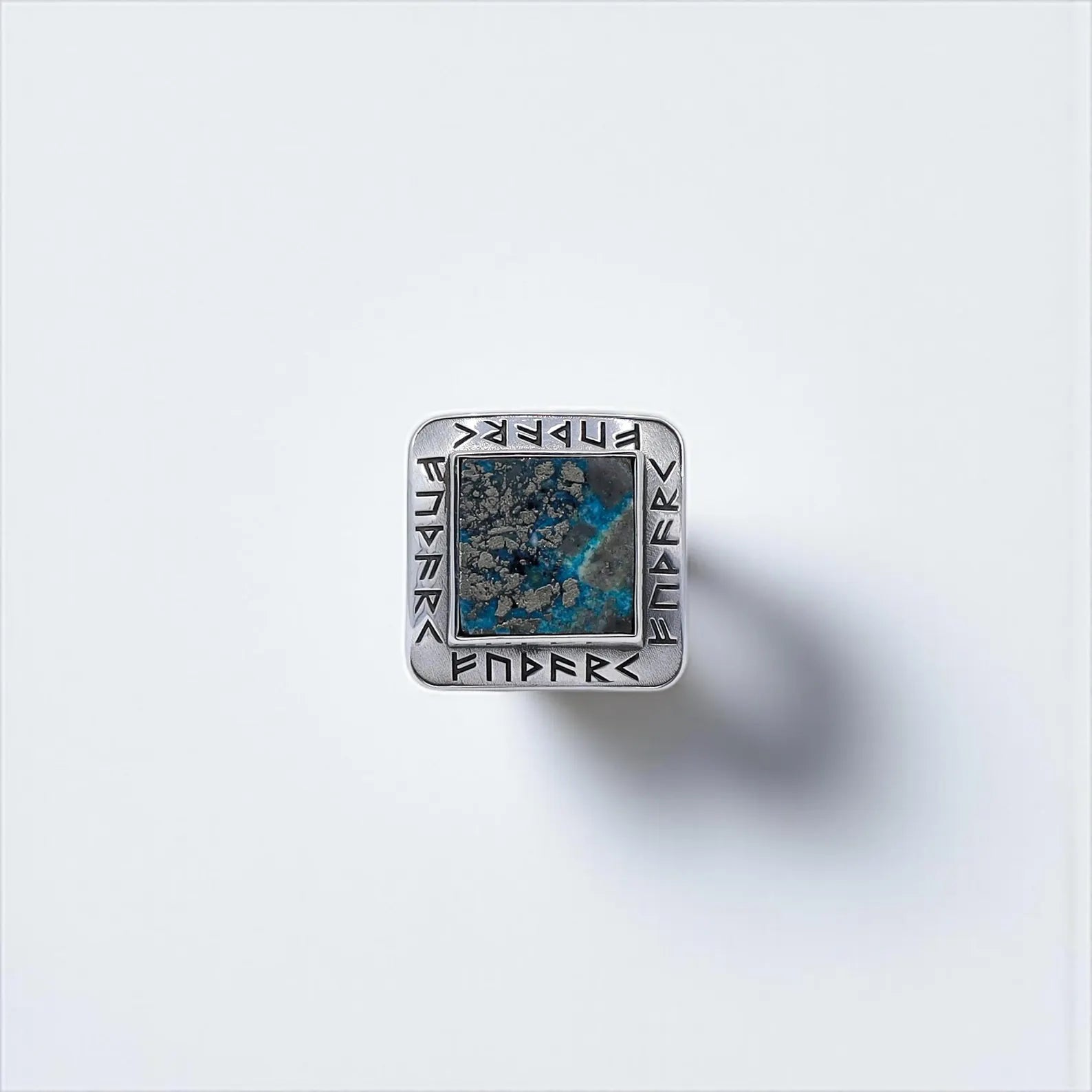 This handcrafted Viking ring features a square turquoise gemstone set in solid sterling silver, surrounded by detailed rune engravings. A powerful men's accessory symbolizing strength, protection, and heritage. Ideal for Shopify gift guides or Pinterest pins on Norse mythology jewelry.