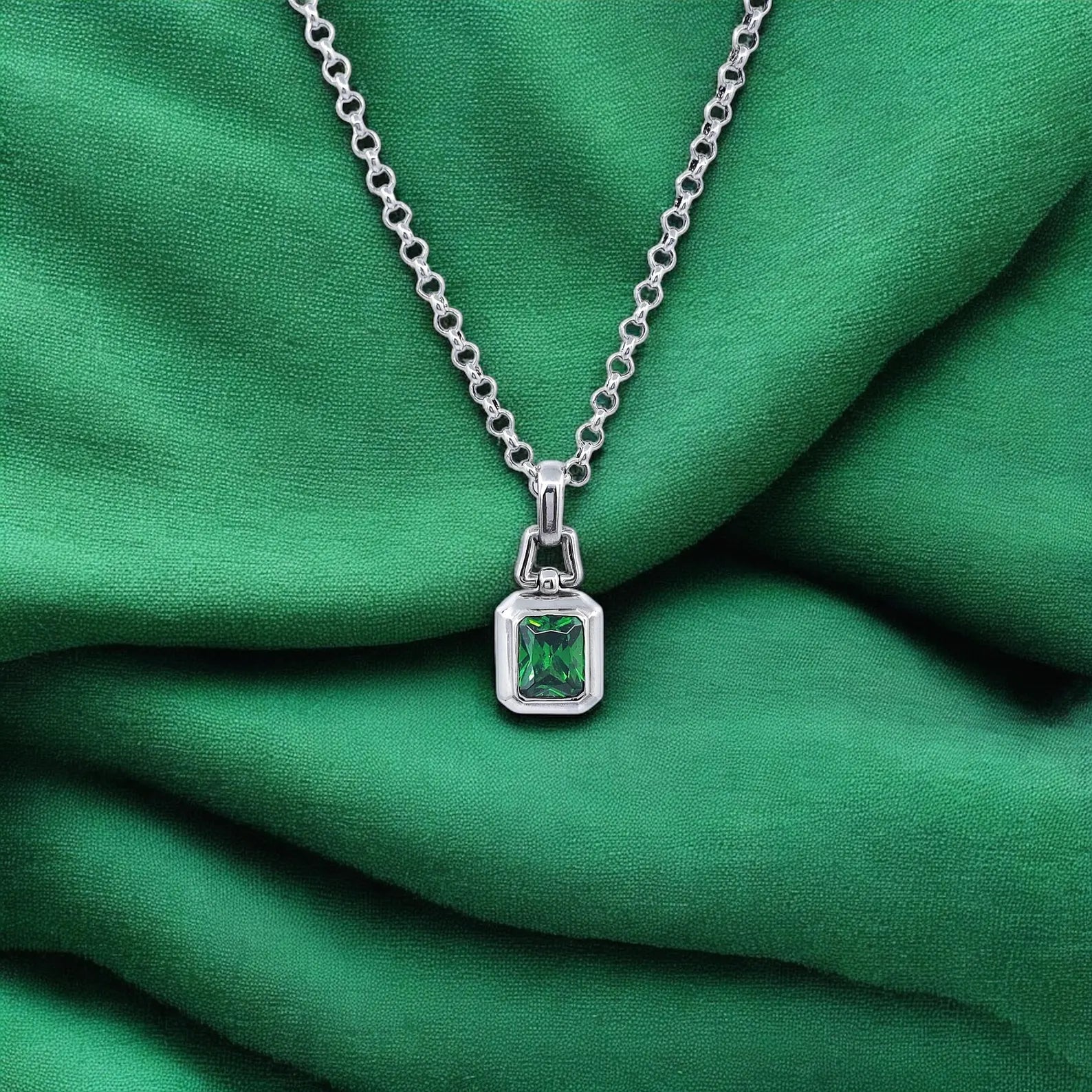 This handcrafted sterling silver necklace features a brilliant emerald green stone cut in a refined rectangular shape, offering a classic yet modern look. The pendant’s polished finish and bold design make it the perfect gift for those who value luxury and minimalist style. Whether worn daily or on special occasions, this piece adds character, charm, and a subtle pop of color to any wardrobe.