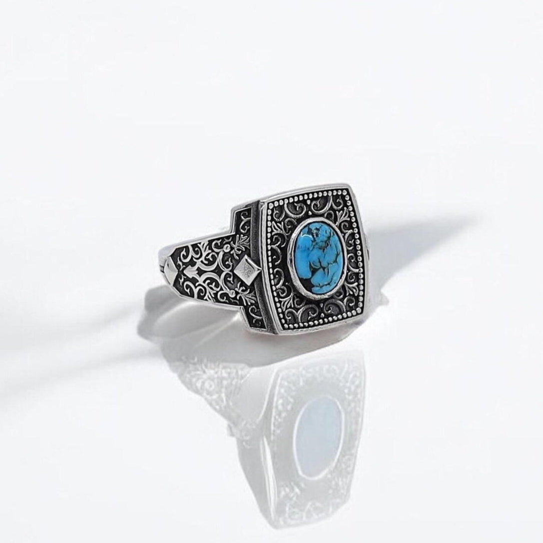 Handmade sterling silver turquoise ring for men featuring a bold square signet design with intricate floral engravings. This vintage western-inspired accessory adds a meaningful and artistic touch to any outfit, making it a standout piece in boho and biker fashion.