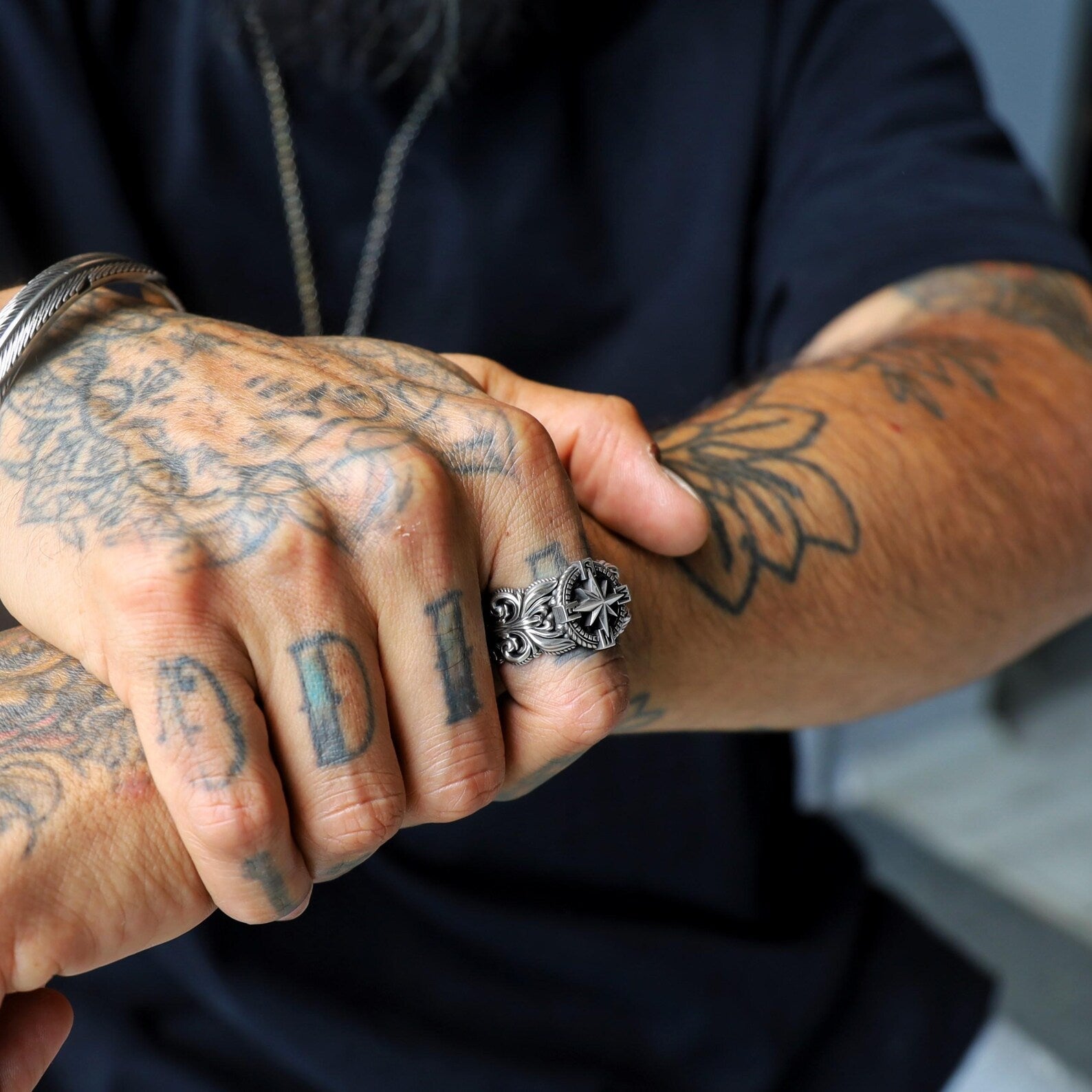 This nautical-themed men’s ring is crafted in sterling silver and features a high-relief compass star at its center. A perfect accessory for those who love the sea or live by the motto "stay the course." Great for Pinterest boards and Instagram posts about meaningful men's jewelry.
