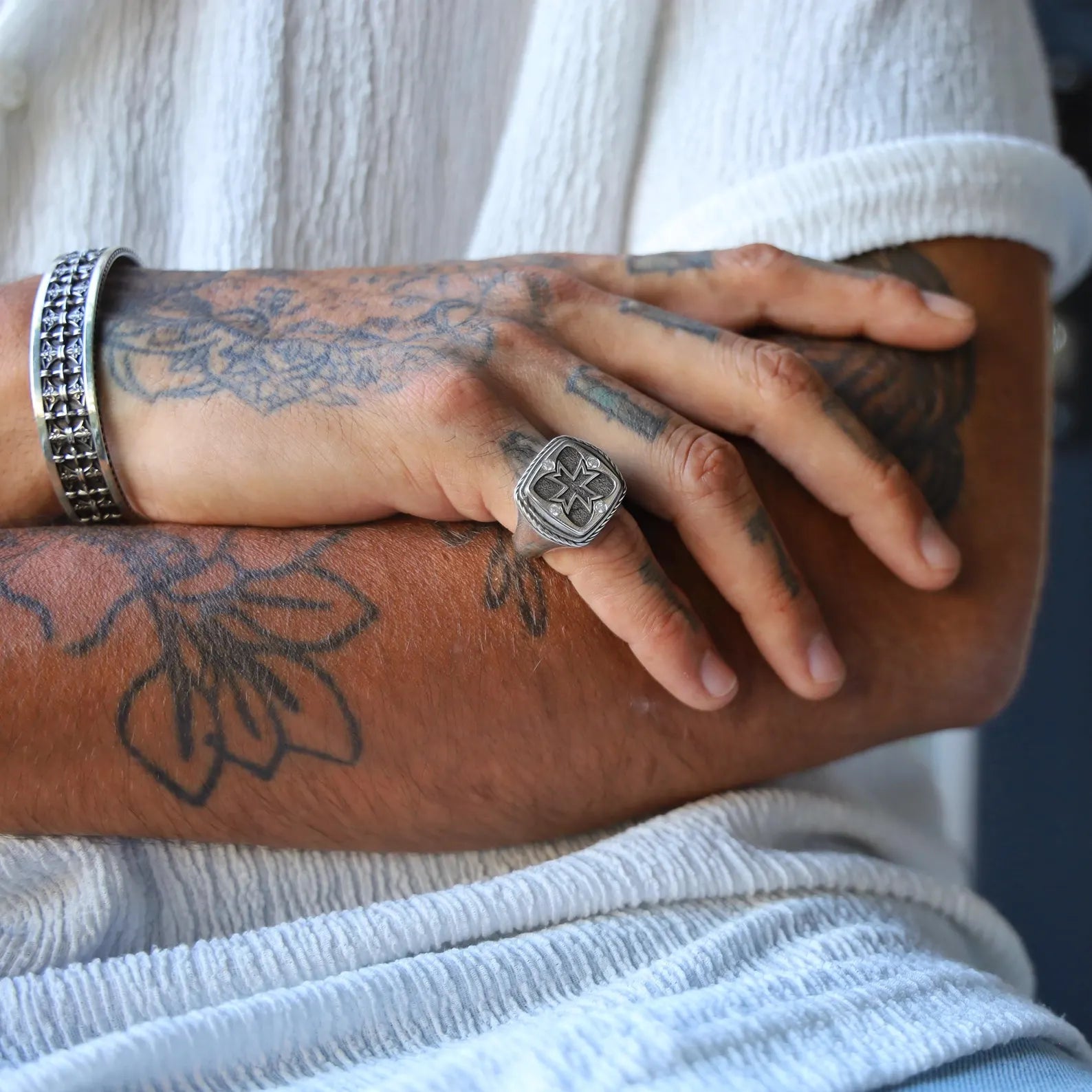 Close-up of a handcrafted sterling silver cross signet ring designed for men, featuring a bold Christian cross engraved on the face, with a polished finish and clean lines, ideal as a meaningful pinky ring and religious gift.