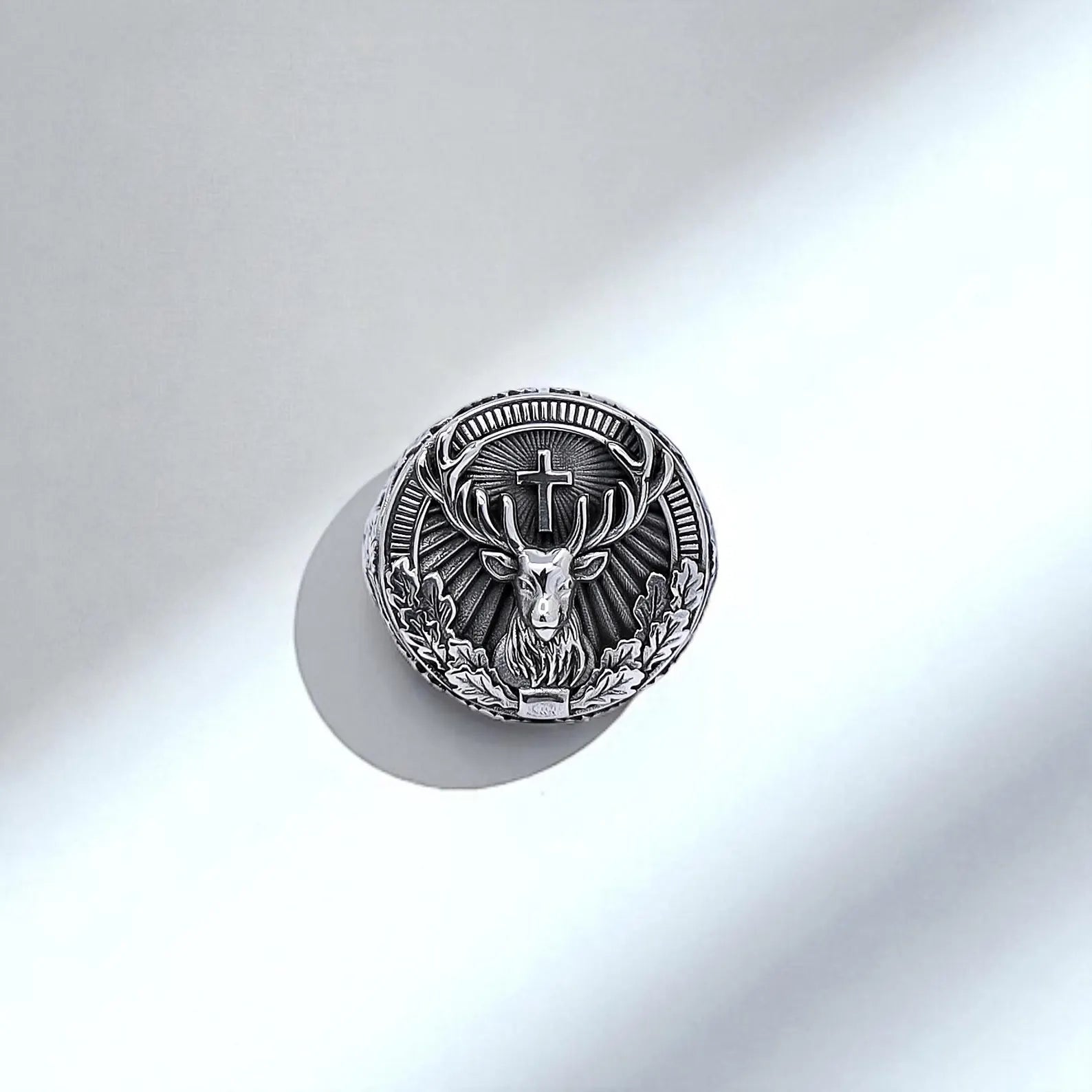 Detailed image of the sterling silver deer ring highlights its hand-polished band and nature-inspired motifs. The blend of smooth and textured surfaces reflects both elegance and rugged masculine energy — a timeless gift for him.