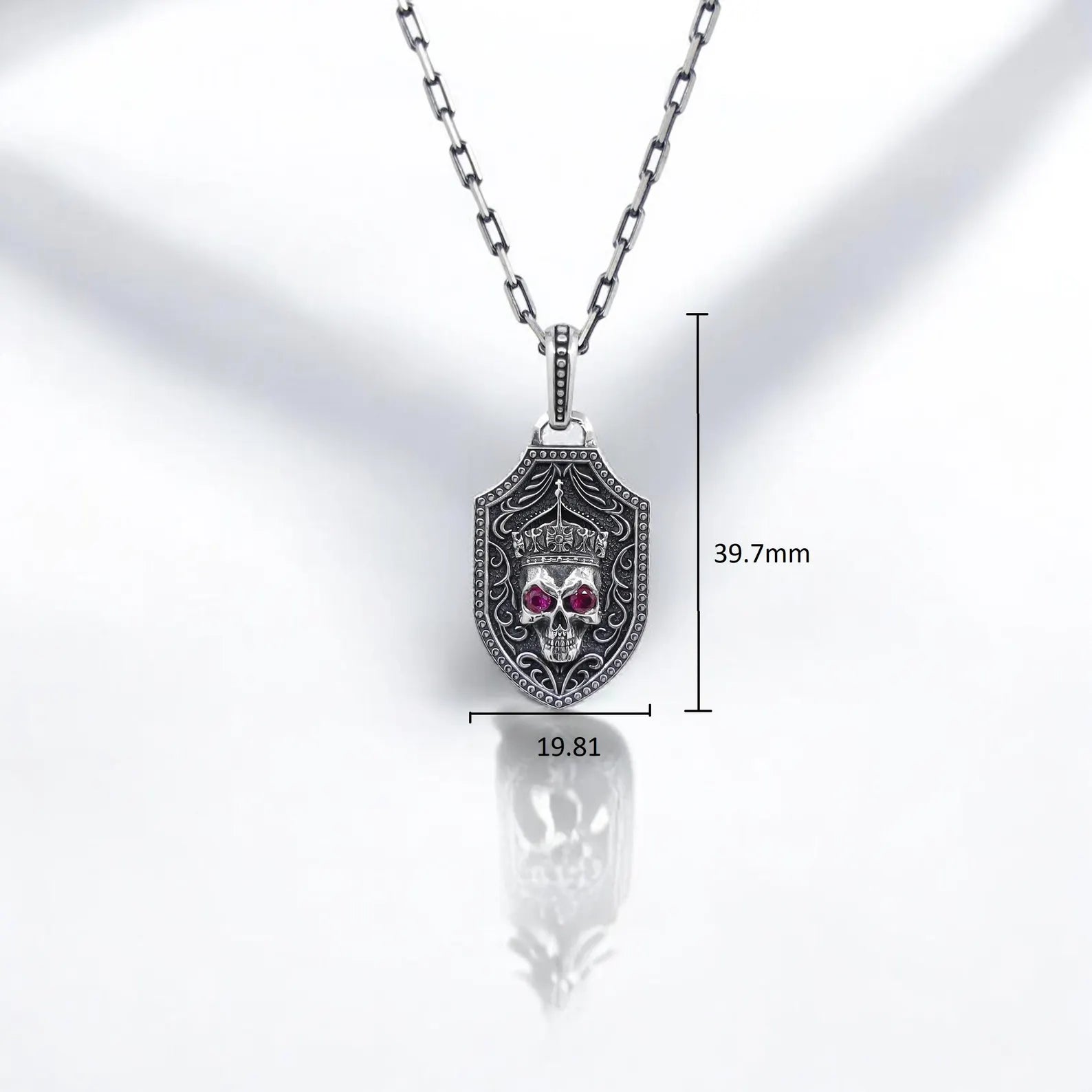 Sterling silver handcrafted necklace with double-sided shield pendant, blending gothic skull design with medieval sword artistry. Red stone eyes and engraved textures make this piece a standout accessory for rock, biker, or punk wardrobes. An unforgettable alternative jewelry gift.