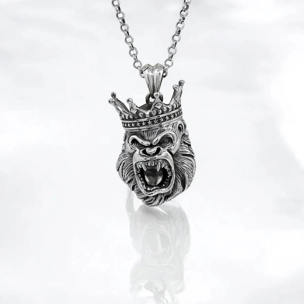 Handcrafted King Gorilla necklace in solid sterling silver, designed to capture the fearless spirit of the wild. Featuring a highly detailed crowned gorilla head pendant, this piece exudes strength, power, and royal presence. Whether you’re drawn to African tribal symbolism or bold animal-inspired fashion, this necklace makes a powerful statement. Ideal for men who lead with confidence and want their jewelry to reflect their personality. A perfect gift for birthdays, anniversary.
