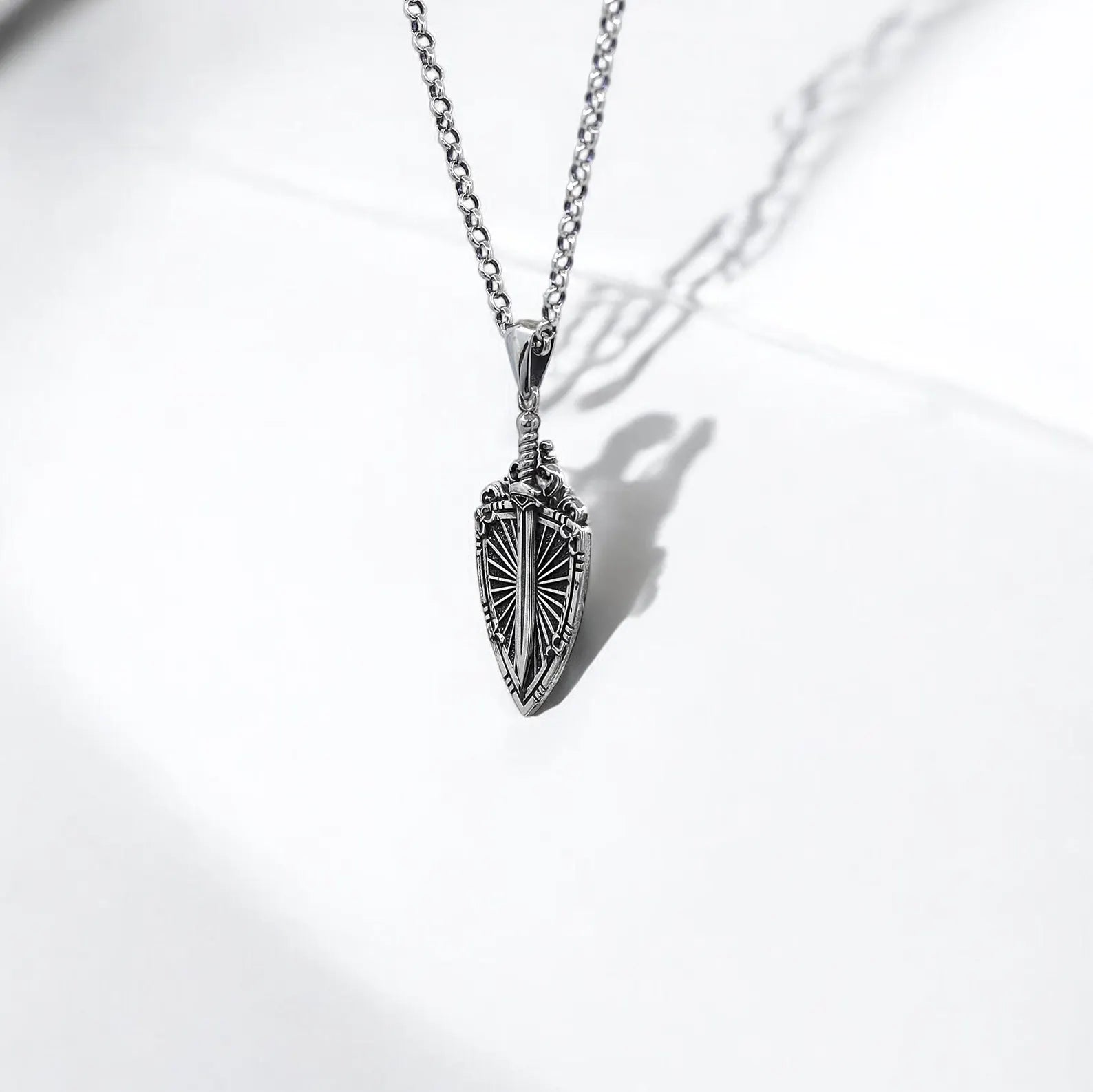 Men’s sterling silver sword pendant with shield design, inspired by medieval knights. Gothic detailing and strong build for daily wear or cosplay events. A meaningful gift for fantasy fans, warriors at heart, and lovers of unique silver jewelry.